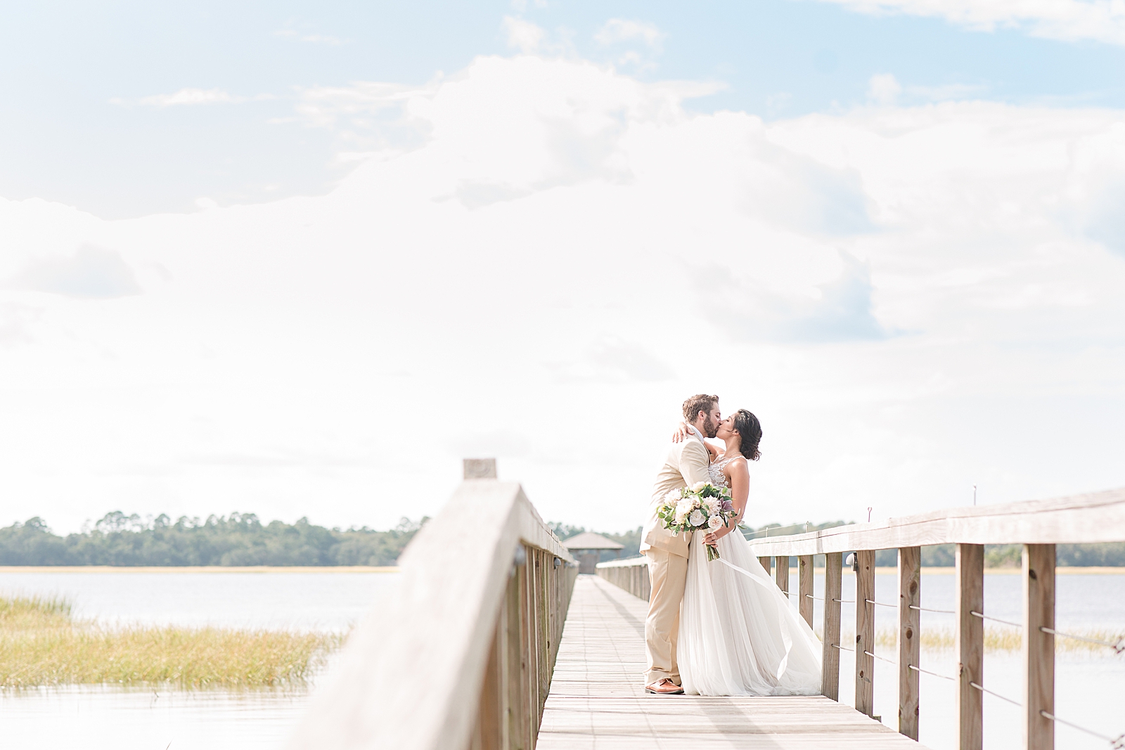 Charleston Wedding at Lowndes Grove Bride and Groom kissing on Dock by the Ashley River Photo