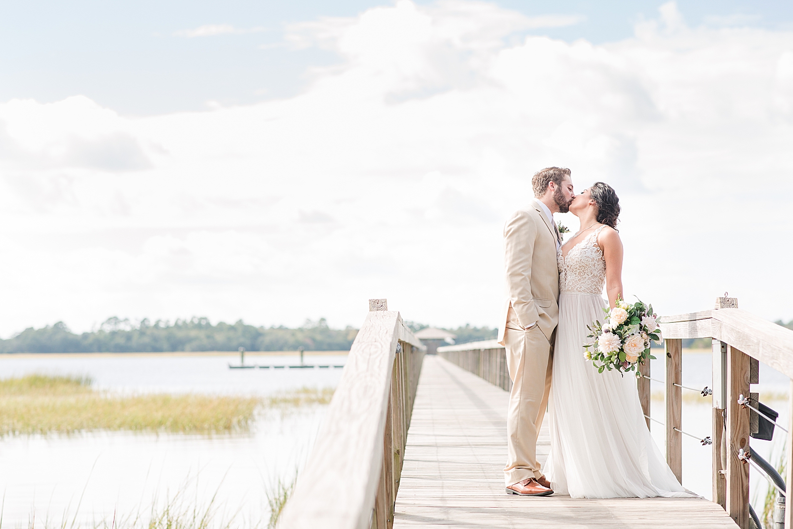 Charleston Wedding at Lowndes Grove Bride and Groom Kissing on Dock on The Ashley River Photo
