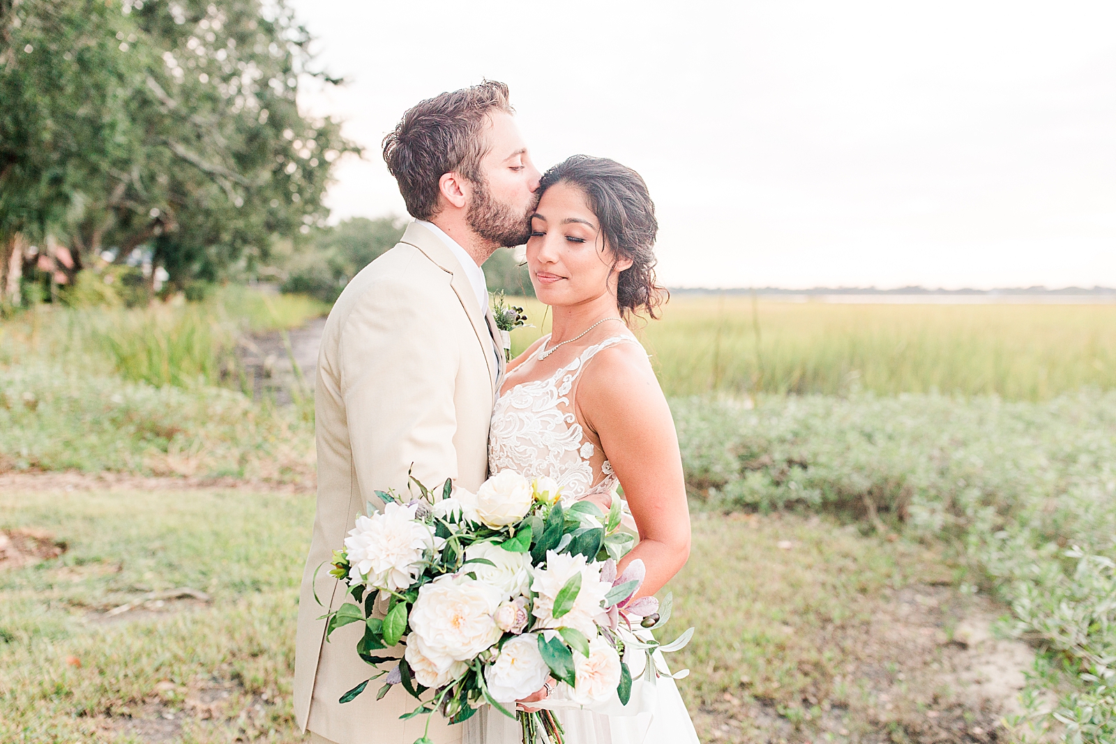 Charleston Wedding at Lowndes Grove Groom kissing bride on head Photo