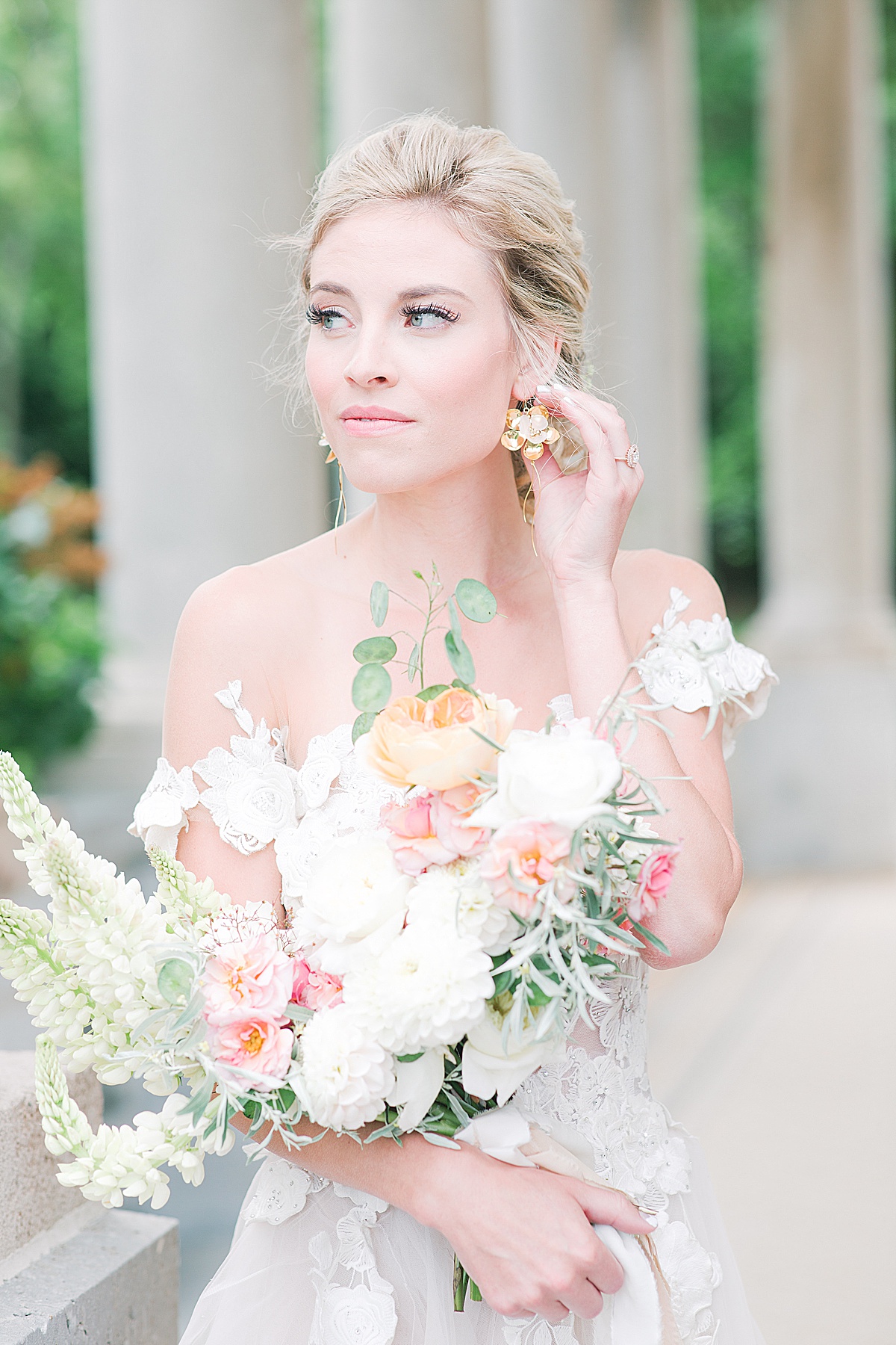 Château Bouffémont Wedding Bride Holding Bouquet and Earring Looking Off Photo