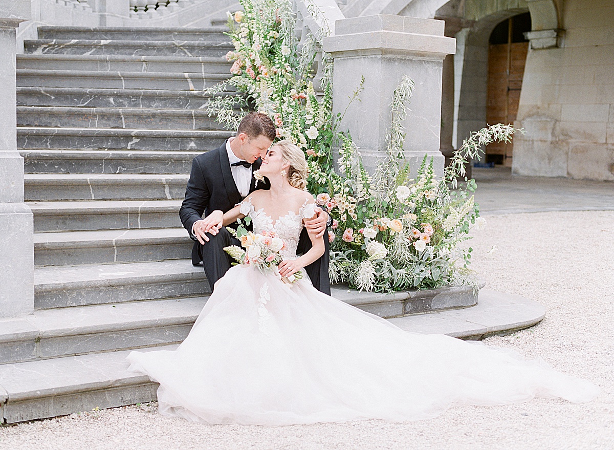 Château Bouffémont Wedding Bride and Groom Nose to Nose sitting on Stairs Photo