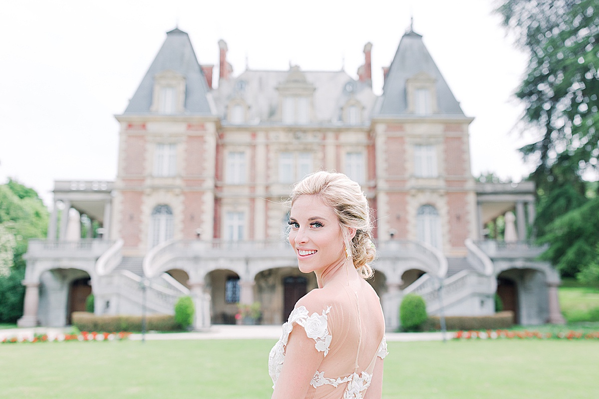 Château Bouffémont Wedding Bride Looking Over her shoulder with Chateau in Background Photo