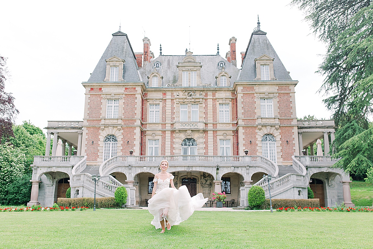 Château Bouffémont Wedding Bride Running Toward Camera with Chateau in Background Photo