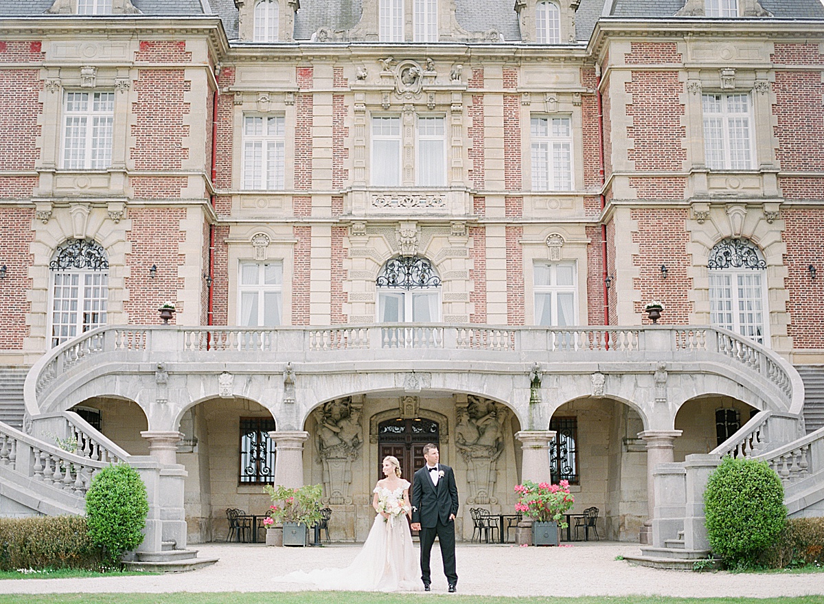 Château Bouffémont Wedding Bride and Groom Holding Hands in Front of Chateau Photo