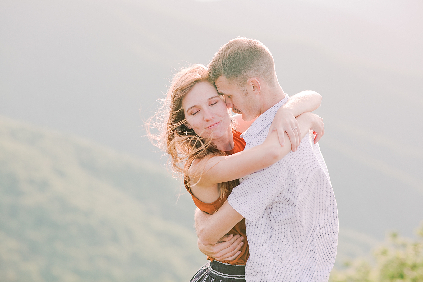 Craggy Gardens Engagement Couple Hugging with Her hair blowing in the wind Photo