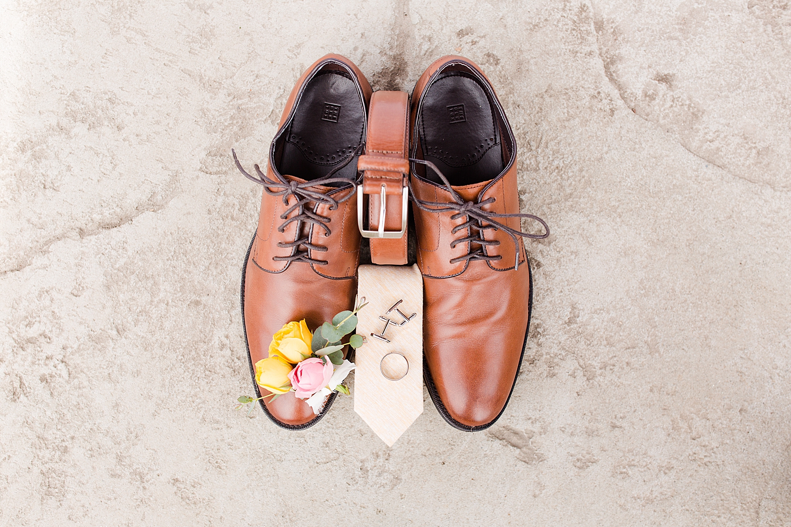 Hackney Warehouse Wedding Grooms Details Belt Tie Shoes Boutonniere on Concrete floor Photo