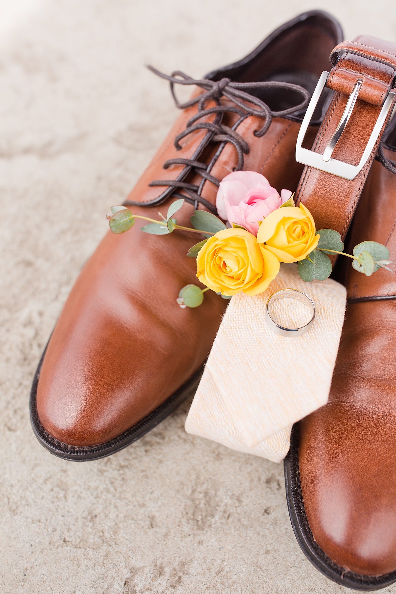 Hackney Warehouse Wedding Details of Grooms Ring Shoes Belt Tie and Boutonniere Photo