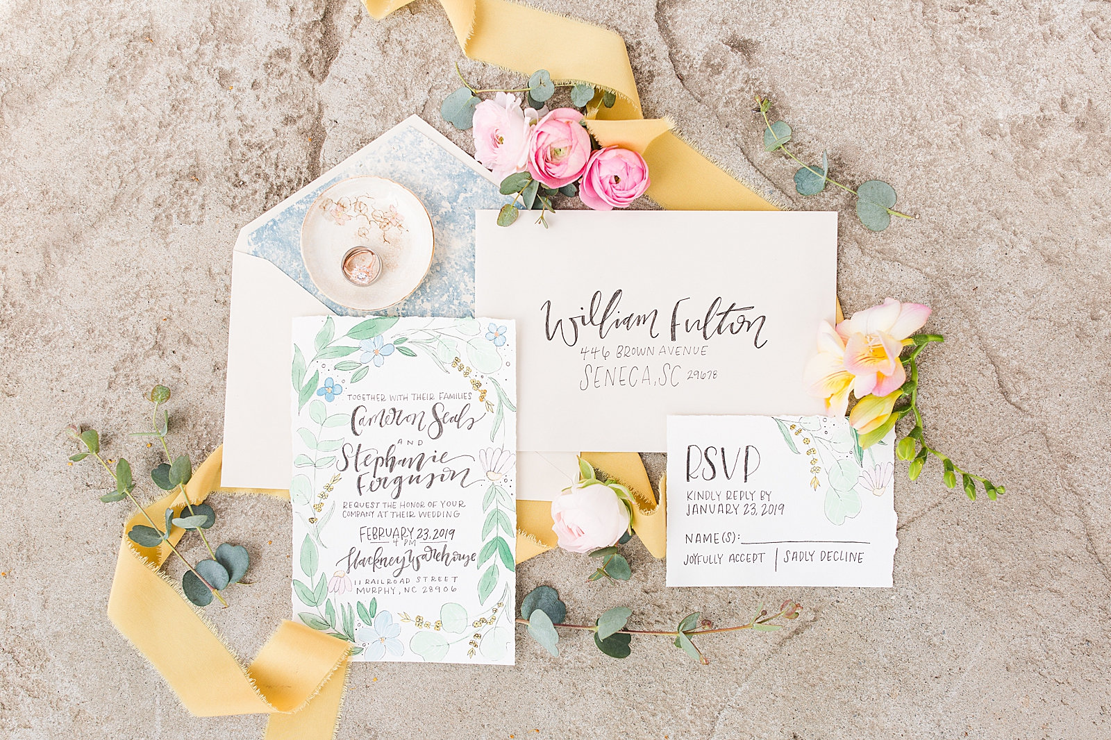 Hackney Warehouse Wedding Invitation Suite with Rings in Ring Dish Yellow Ribbon and Pink Flowers Photo