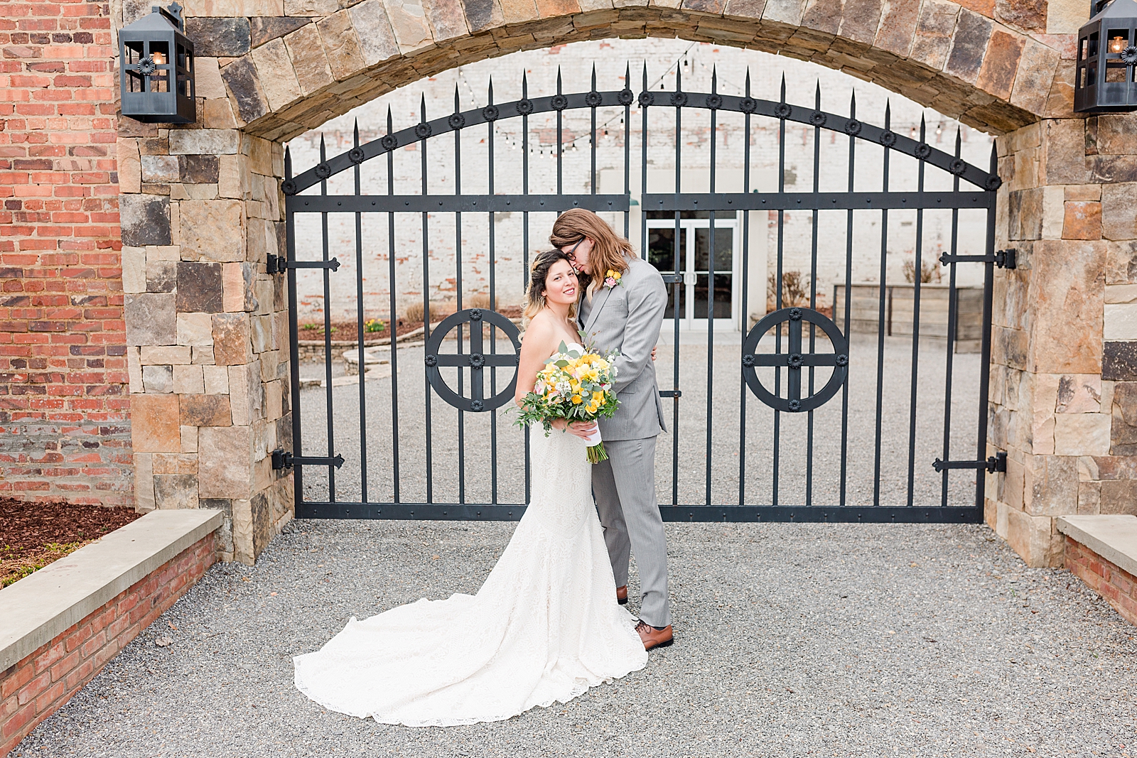 Hackney Warehouse Wedding Couple hugging in front of iron gate Photo