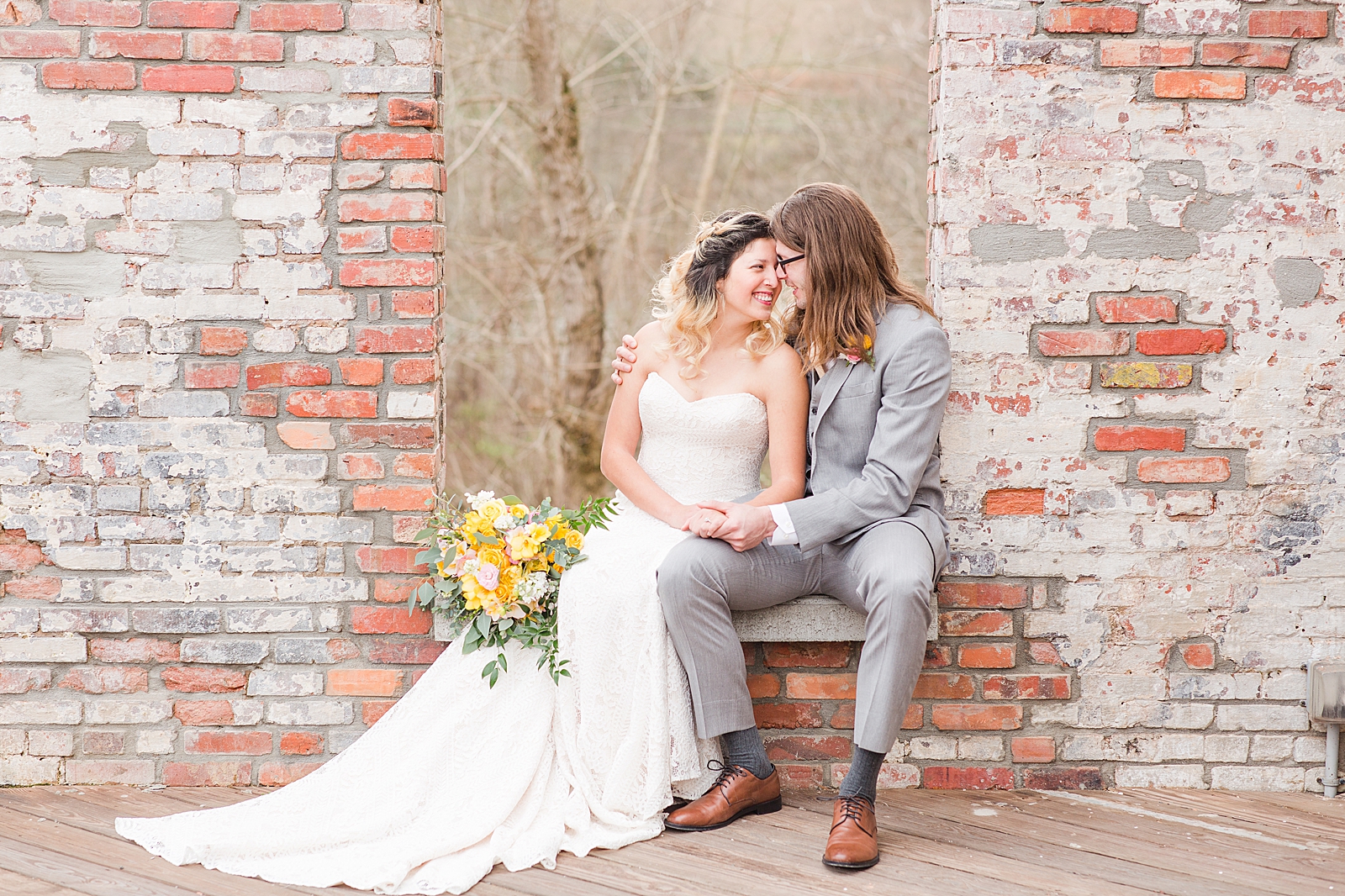 Hackney Warehouse Wedding Bride and Groom Sitting in Window nose to nose smiling Photo
