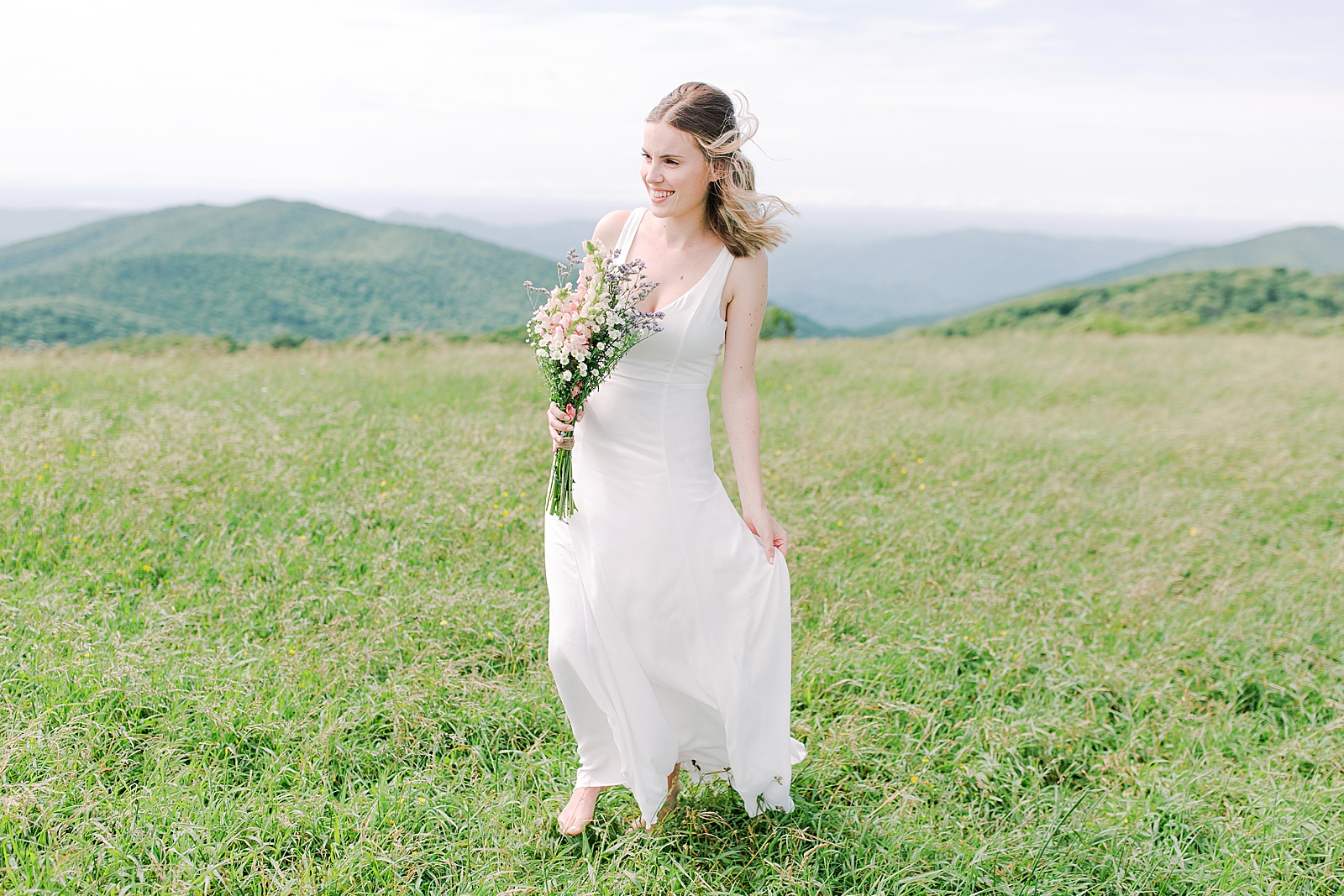 Max Patch Elopement Bride Walking Through the Field Smiling Photo