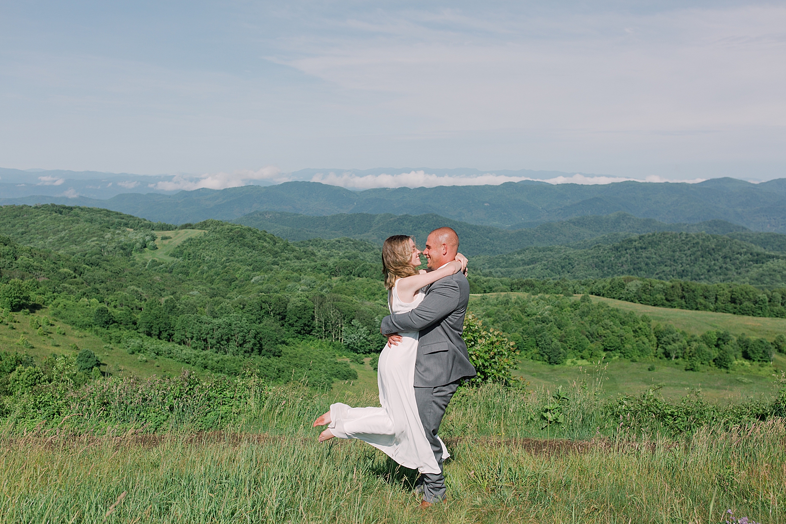 Max Patch Elopement Groom Spinning Bride in Field Photo