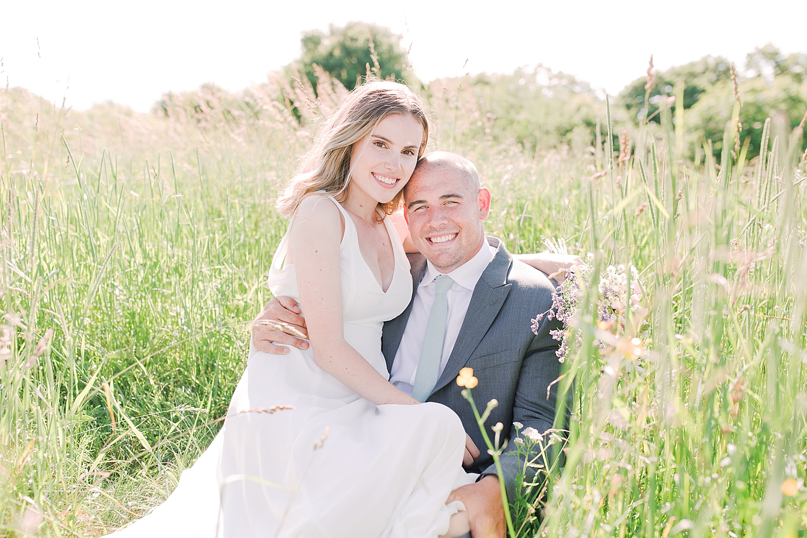 Max Patch Elopement Bride and Groom Sitting in Tall Grass Photo