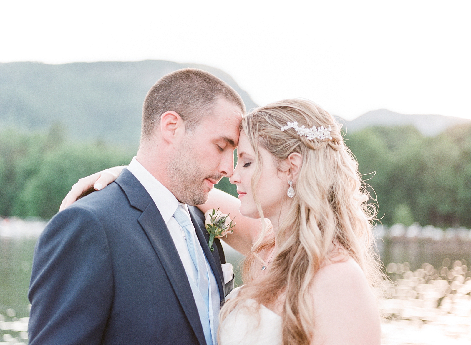 Rumbling Bald Resort Wedding Bride and Groom nose to nose with mountain and lake in the background Photo