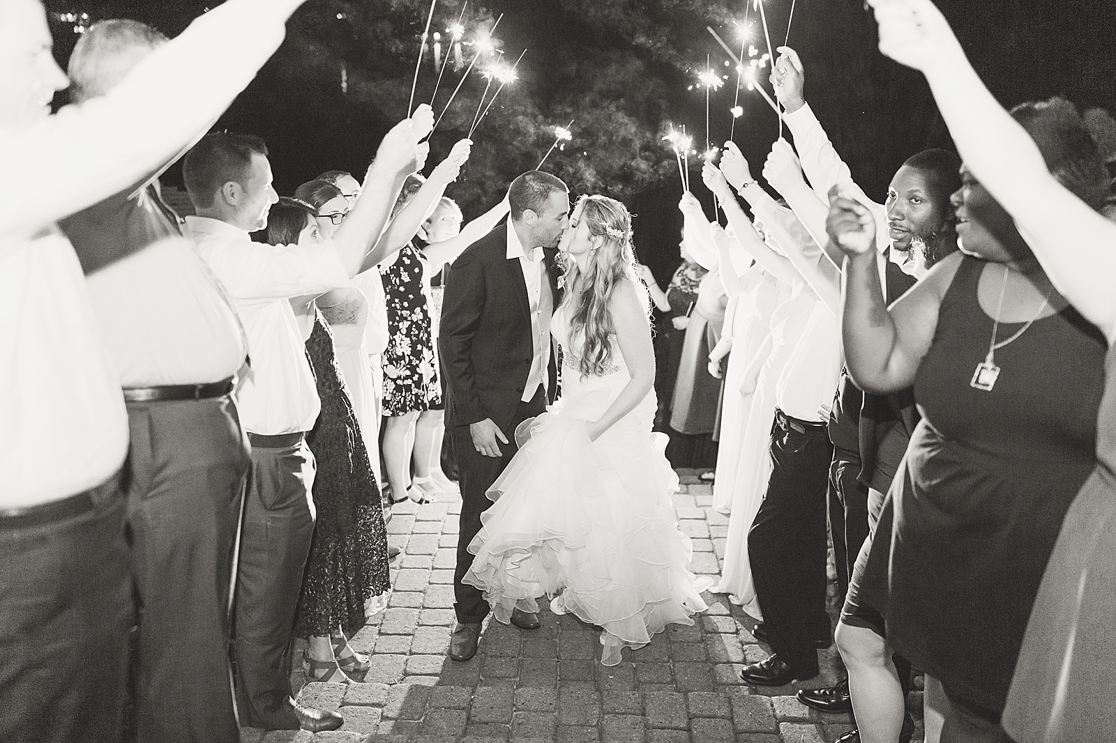Rumbling Bald Resort Wedding Black and White of Couple Kissing On Sparkler Exit Photo