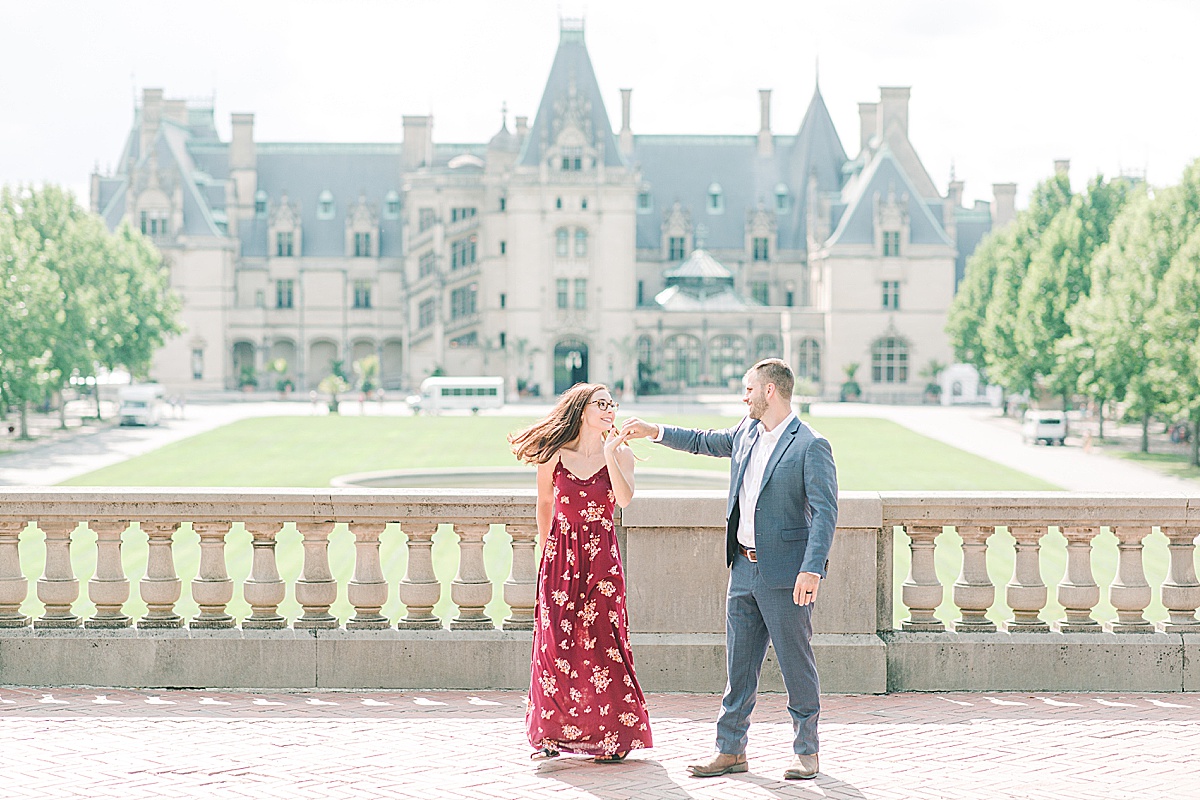 Biltmore Estate Anniversary Session Couple spinning in front of house Photo
