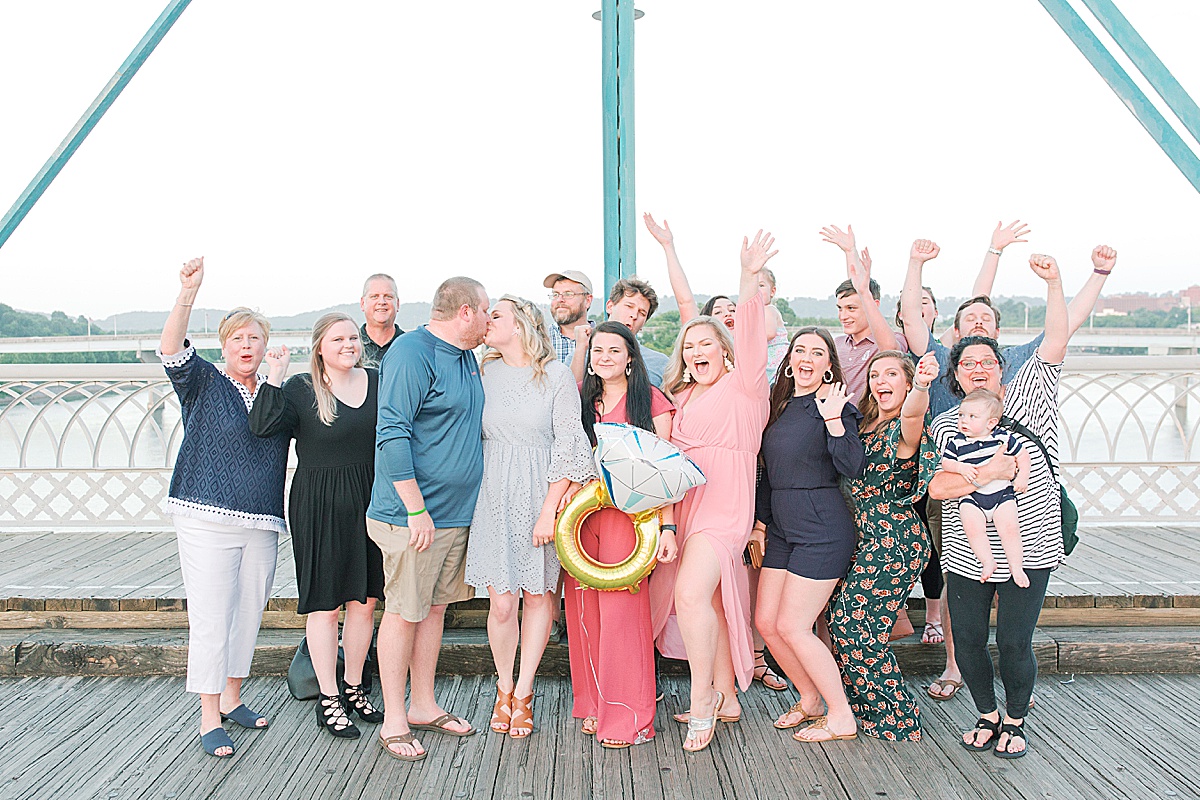 Chattanooga Proposal Group Photo of couple kissing and everyone cheering Photo