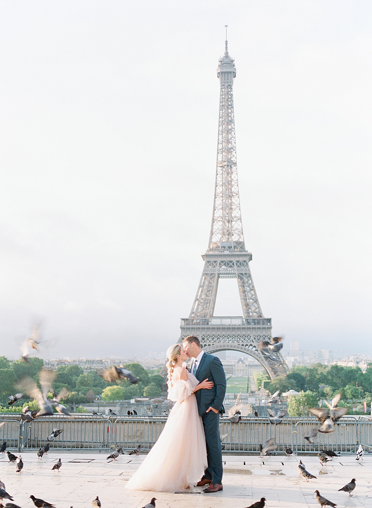 Eiffel Tower Wedding Bride and Groom Kissing with Birds Flying around Photo