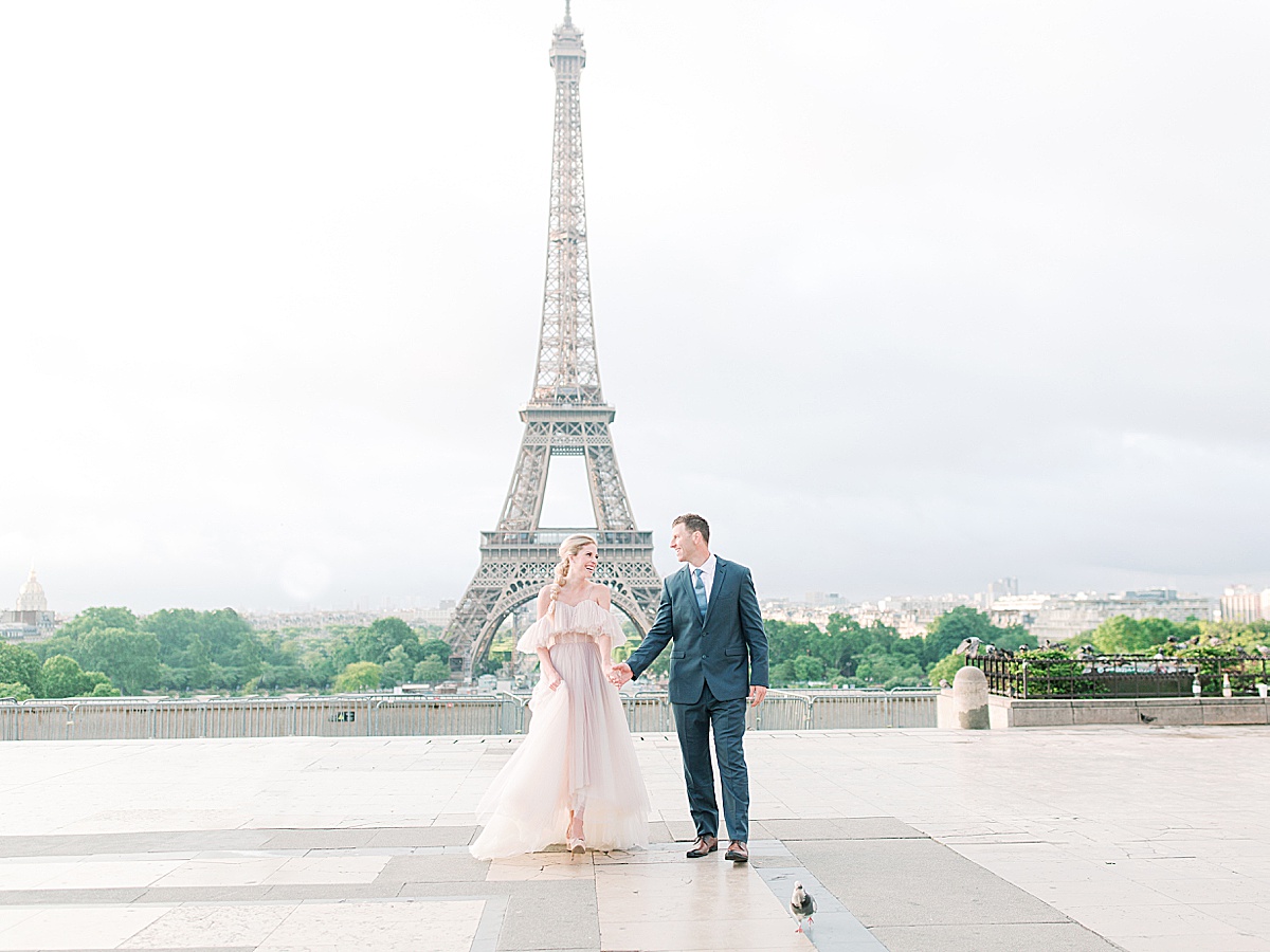Eiffel Tower Wedding Bride and Groom walking toward camera holding hands Photo