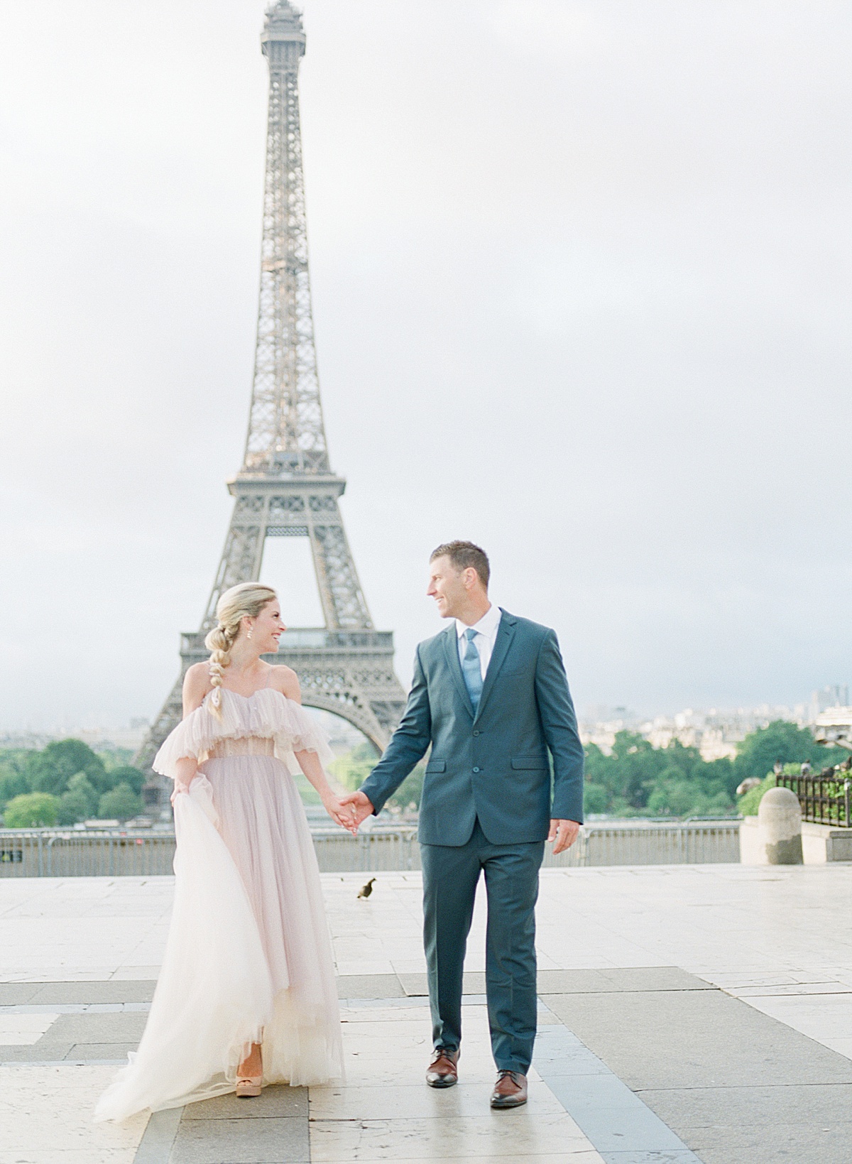 Eiffel Tower Wedding Couple holding hands smiling at each other Photo
