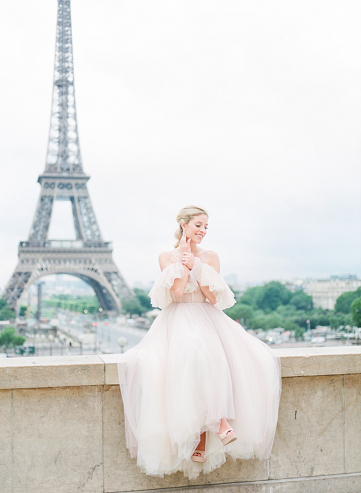 Eiffel Tower Wedding Bride sitting on Wall Photo