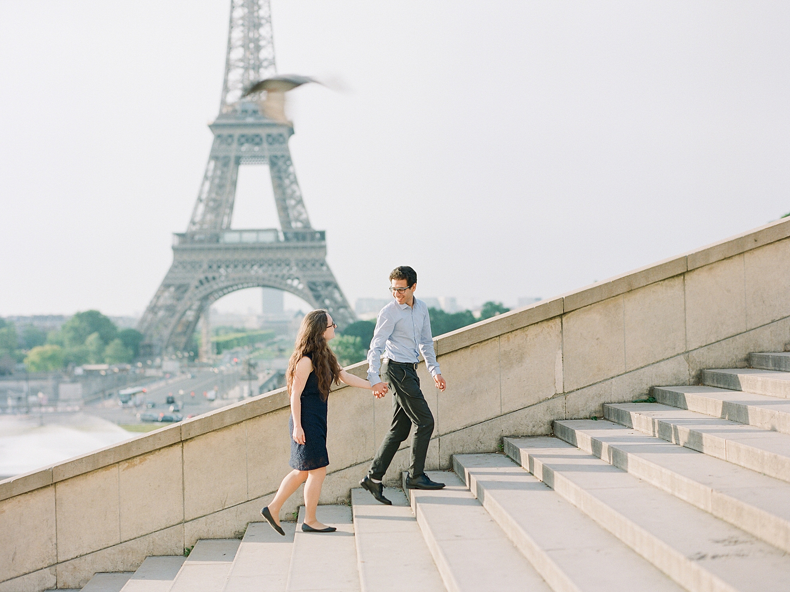 Eiffel Tower Engagement Session Couple walking up stairs Photo