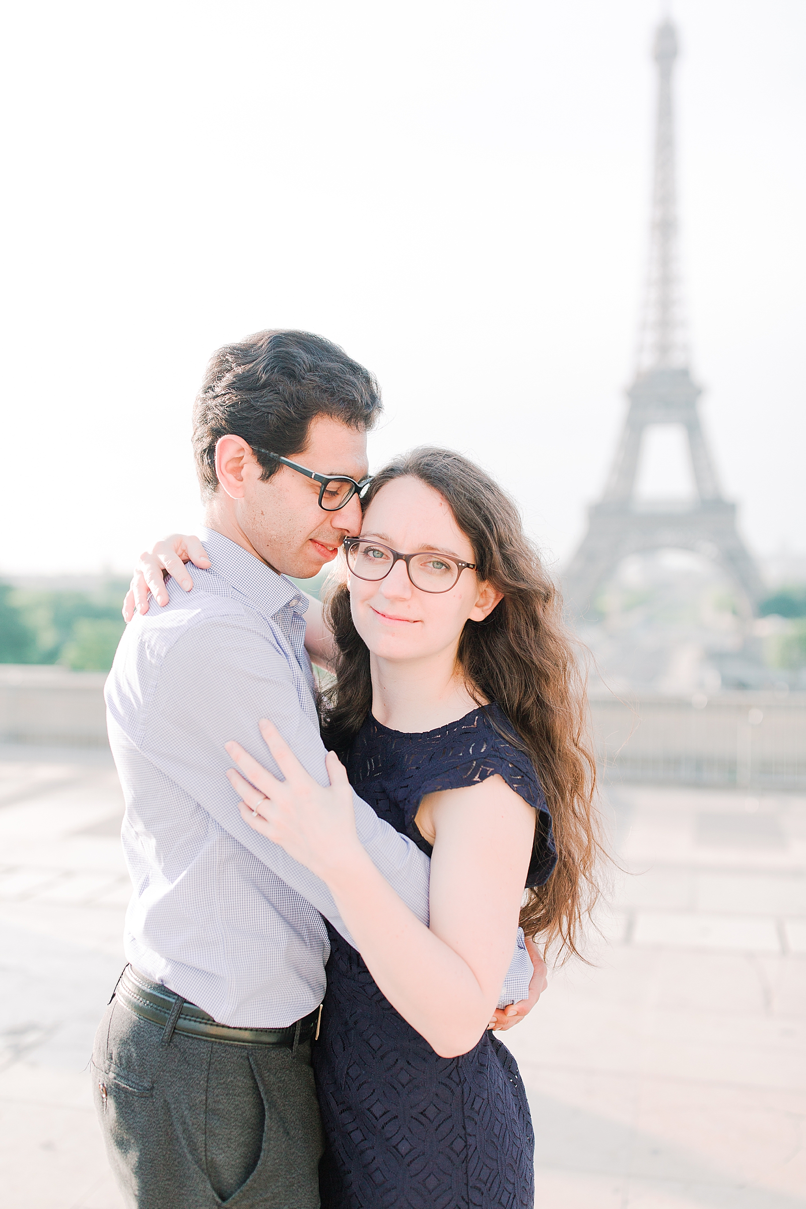 Eiffel Tower Engagement Session Nadia looking at camera Rafik nuzzled in Photo