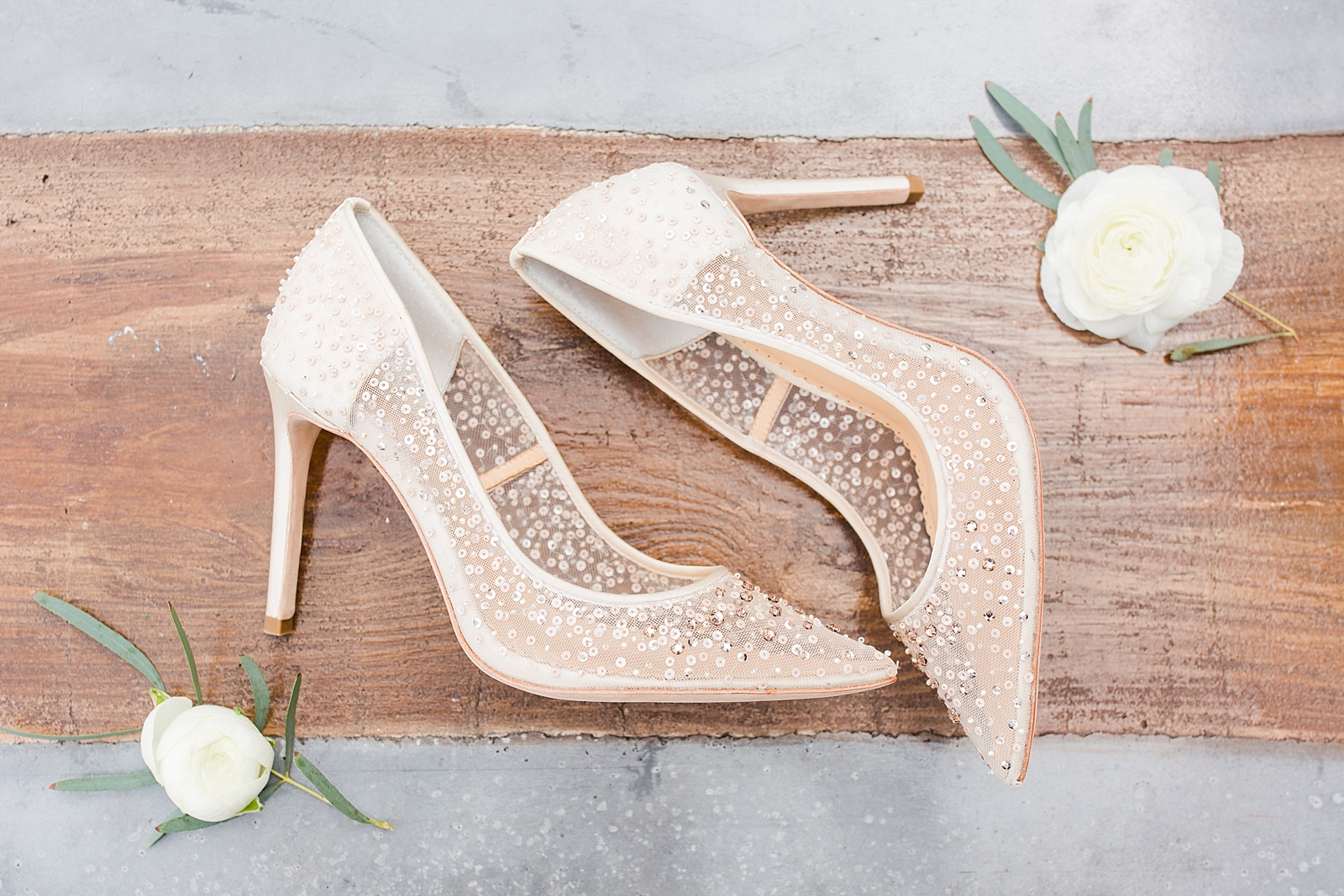 Glover Park Brewery Wedding Bridal shoes with white roses on wood and concrete table Photo