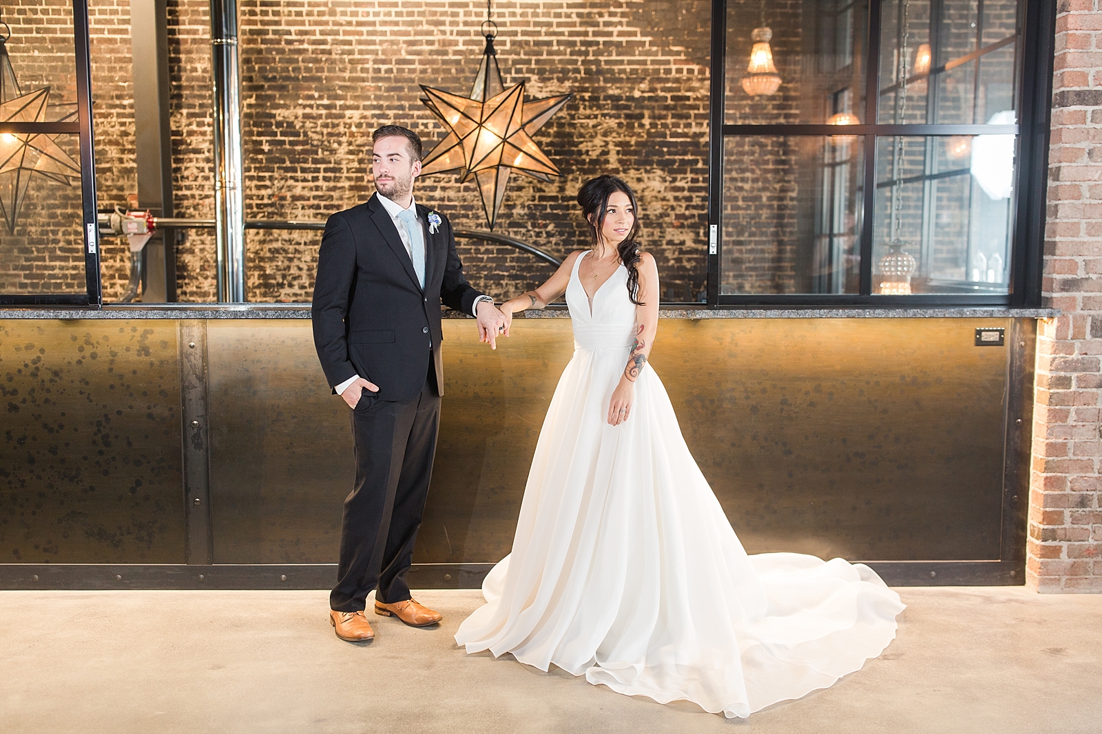 Glover Park Brewery Wedding Bride and Groom holding hands in venue in front of star light fixture Photo