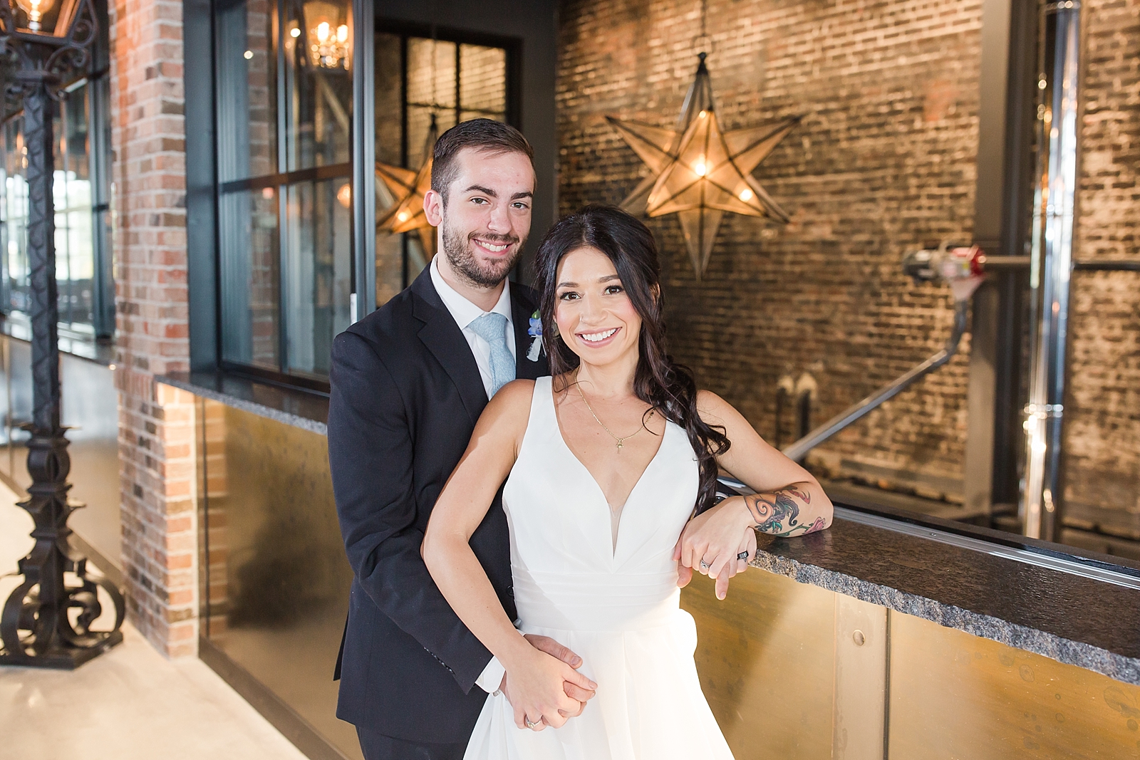 Glover Park Brewery Wedding Bride and Groom holding hands in venue in front of star lights Photo