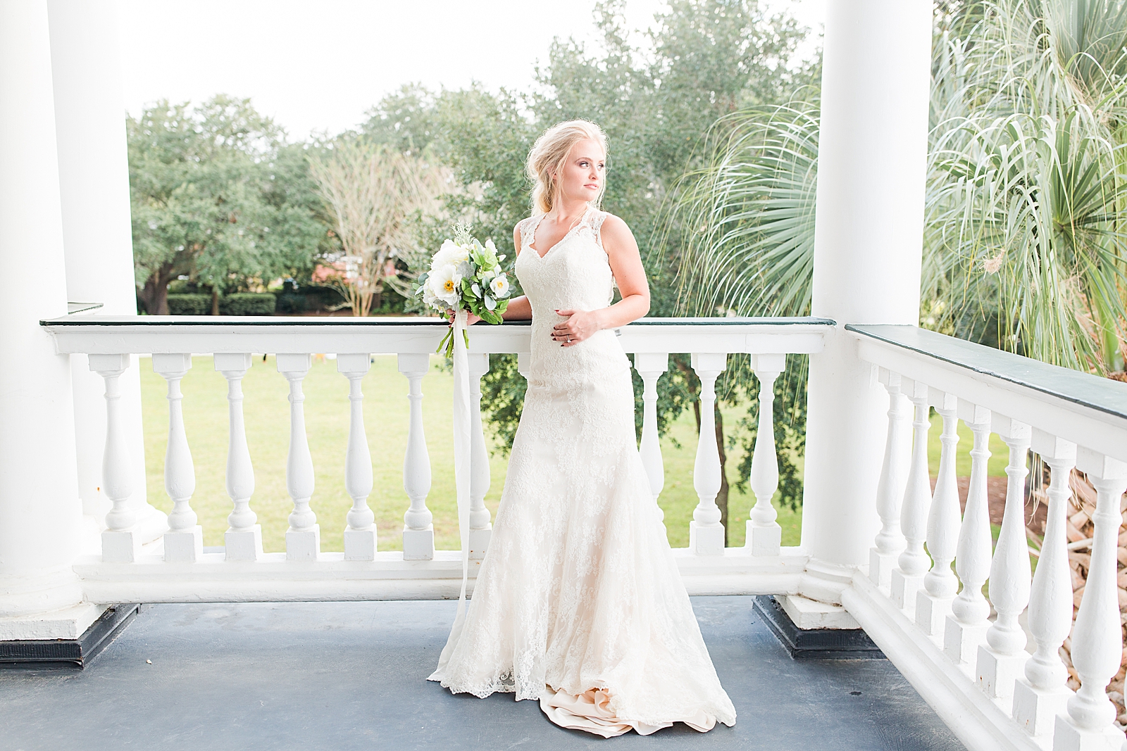 Charleston Photography Bridal Session Bride leaning on railing of porch looking over her shoulder Photo