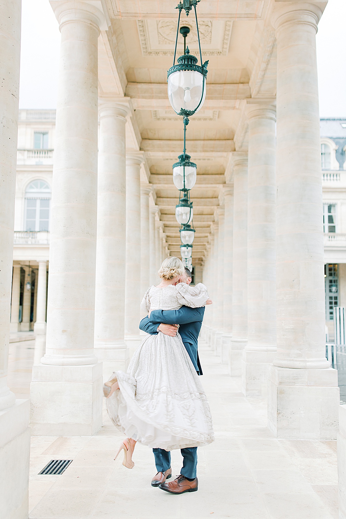 Palais Royal Engagement Couple Spinning in Between pillars Photo