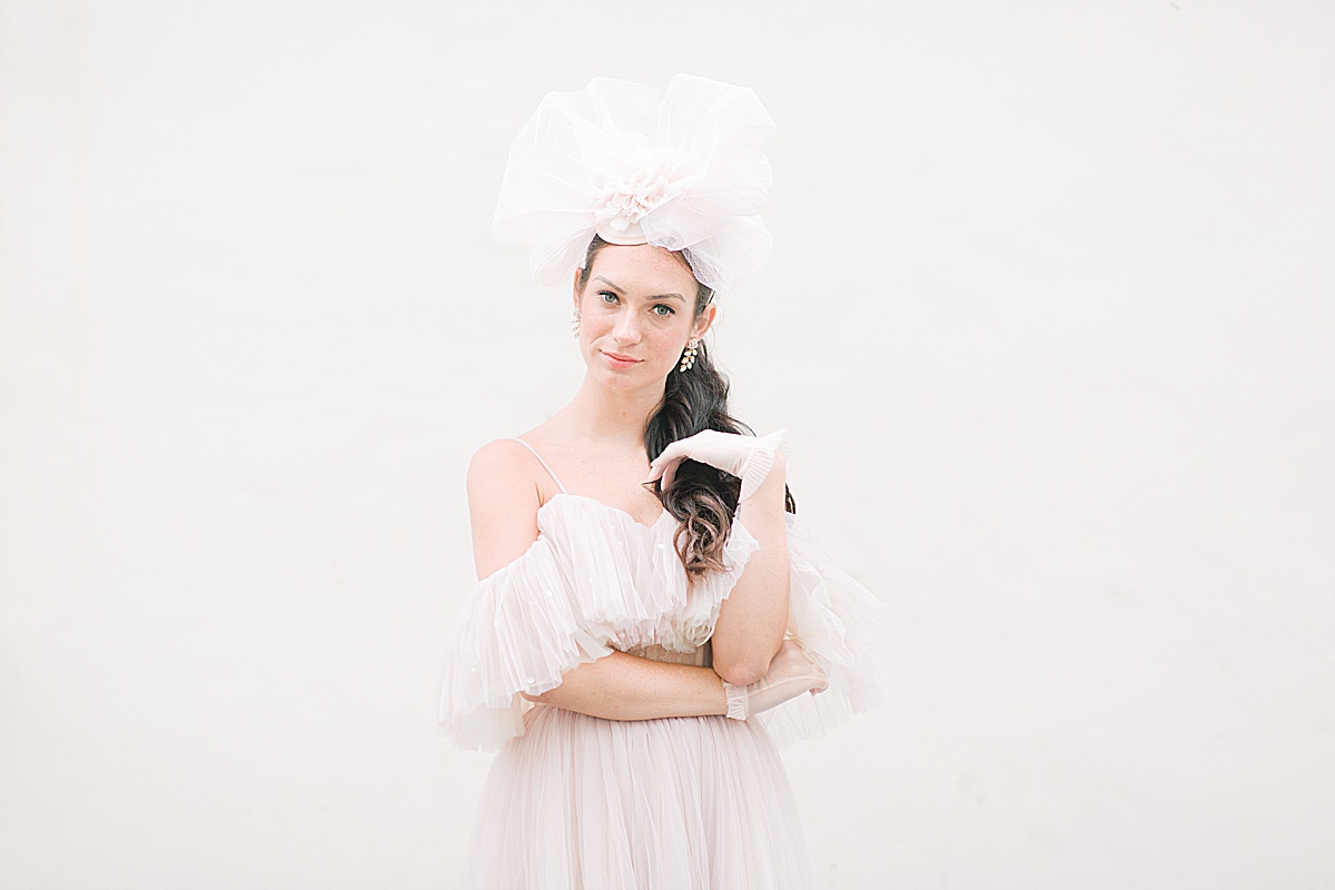 Paris Bridal Fashion Katie in Light pink Dress and Hat against White wall Photo