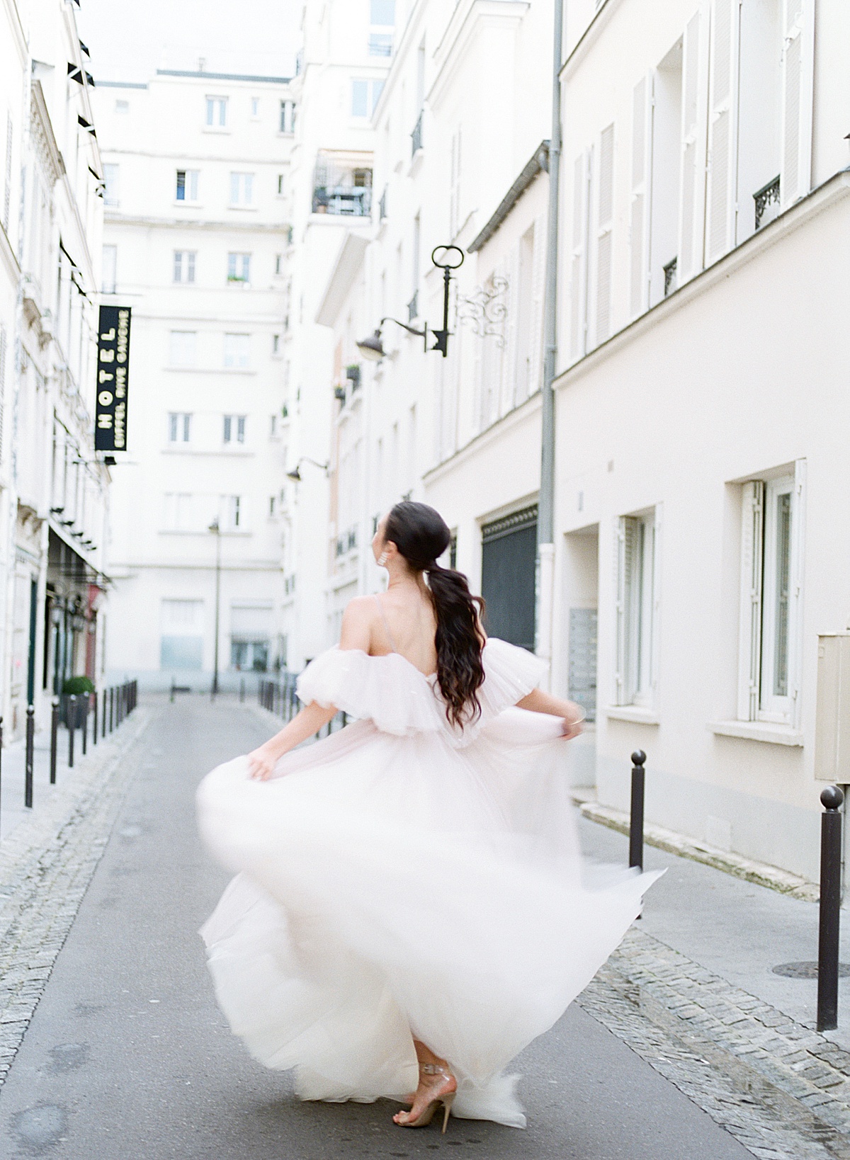 Paris Bridal Fashion Film Photography shot of bride spinning in street Photo