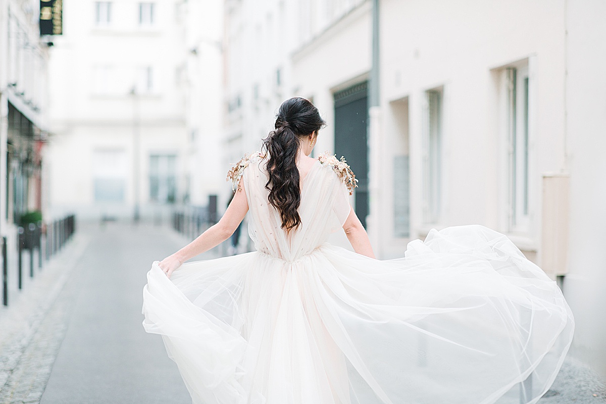 Paris Bridal Fashion Editorial bride walking down street dress blowing in the wind Photo