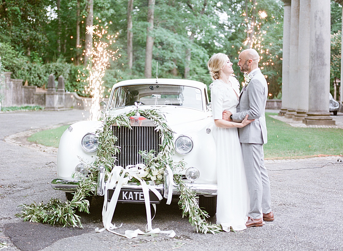 Swan House Wedding Bride and Groom Laughing in front of Car with Sparklers Photo