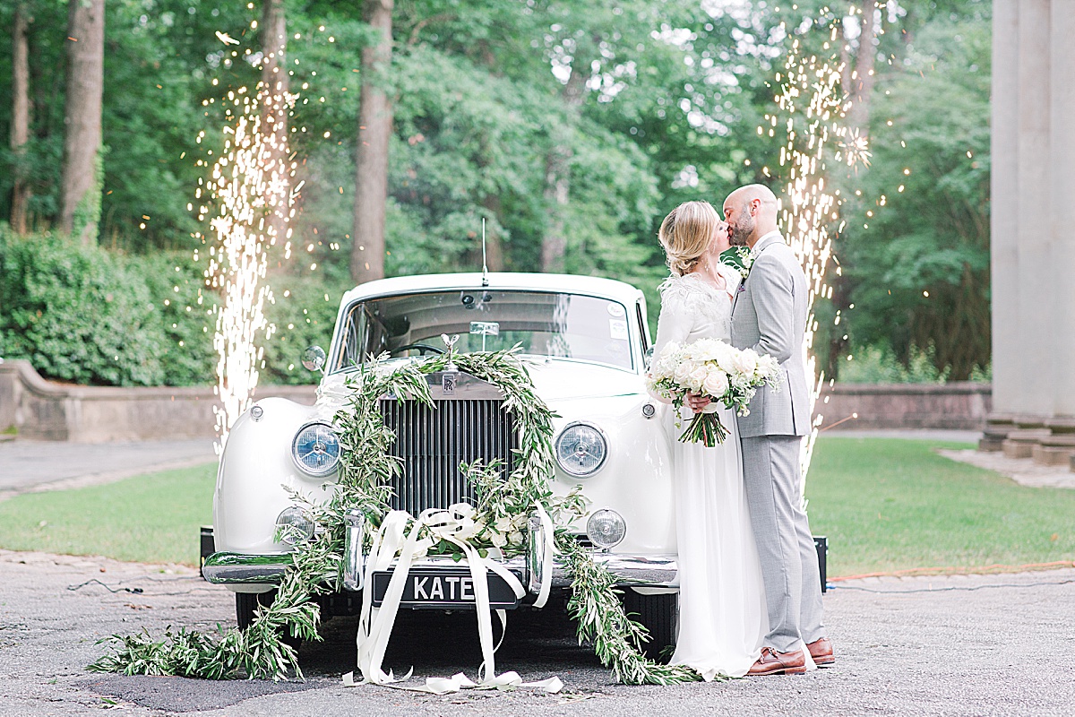 Swan House Wedding Bride and Groom Kissing in Front of Vintage Car with Sparklers Photo