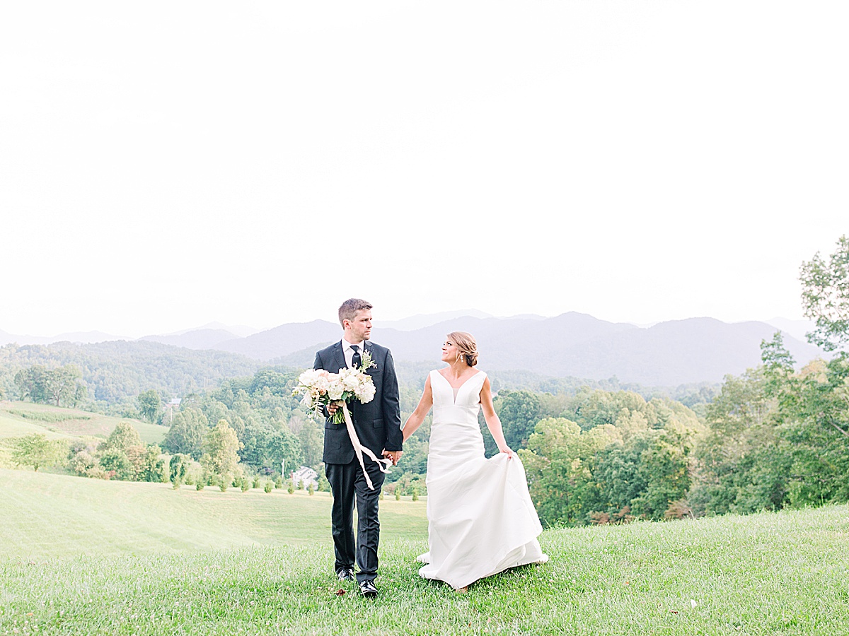 The Ridge Asheville Wedding Bride and Groom Holding Hands Walking Toward Camera Photo