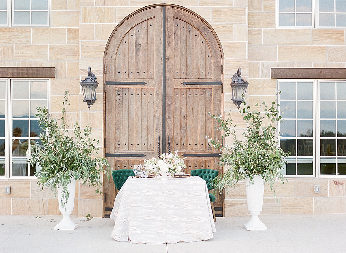 Sweetheart wedding table in front of wooden doors at Asheville Wedding Venue The Ridge Photo
