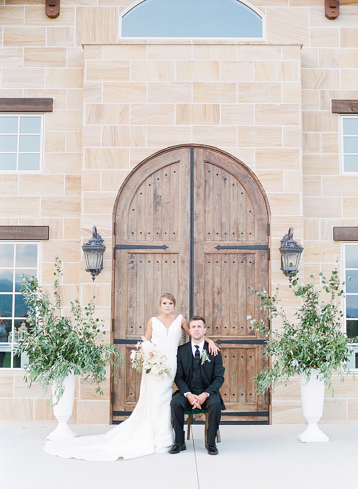 The Ridge Asheville Wedding Couple in front of wood doors of chateau Photo