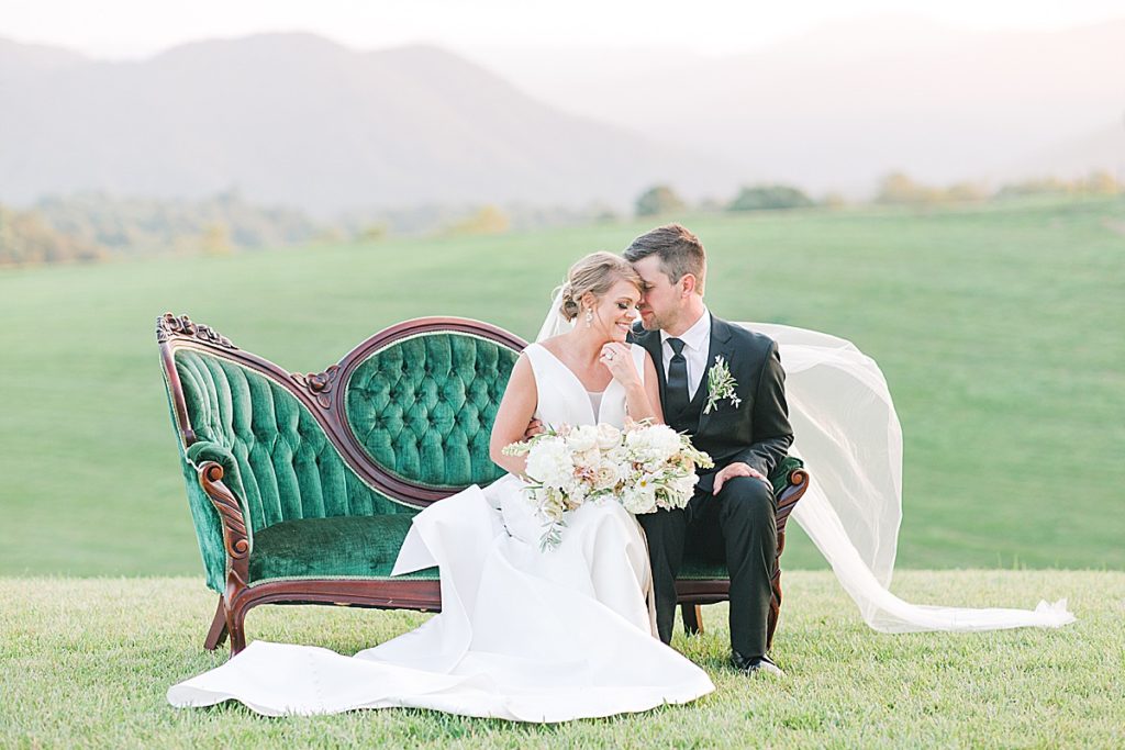 Bride and Groom Sitting on a Green Couch at The Ridge Asheville Wedding Venue Photo 