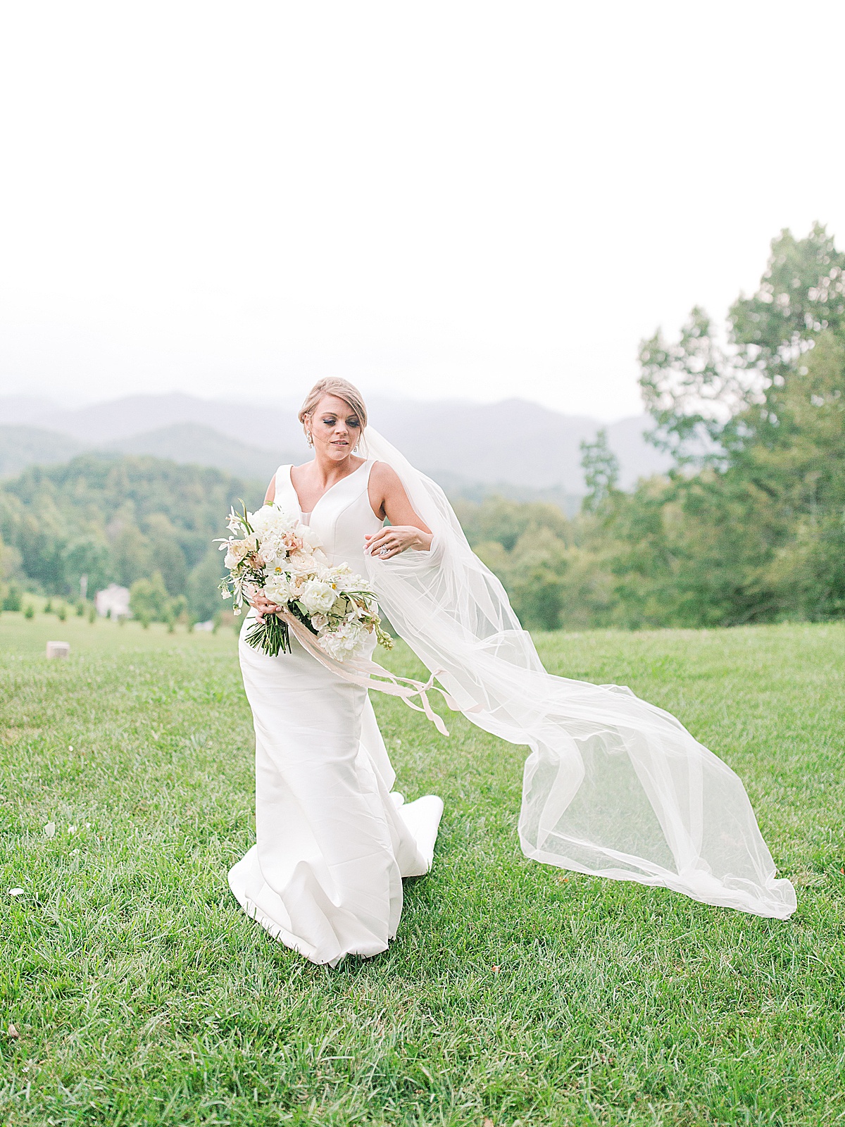 The Ridge Asheville Wedding Bride walking toward camera and veil blowing Photo