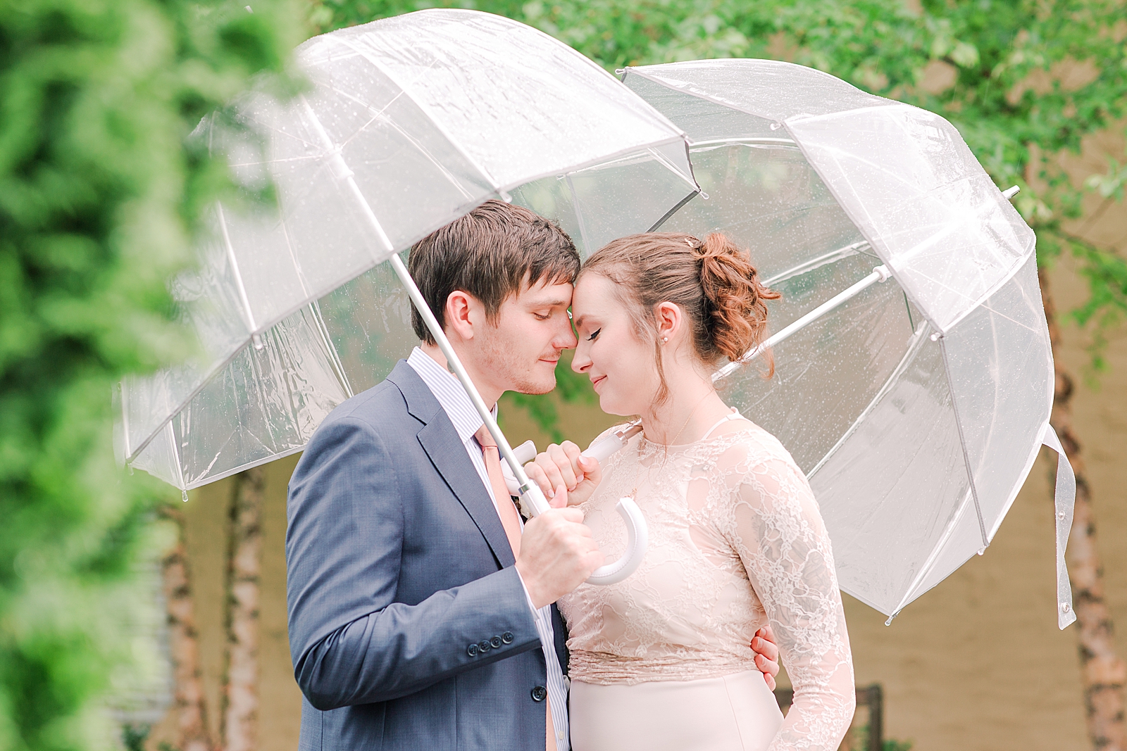 Rainy Wedding Day Couple Under Umbrellas Photo 