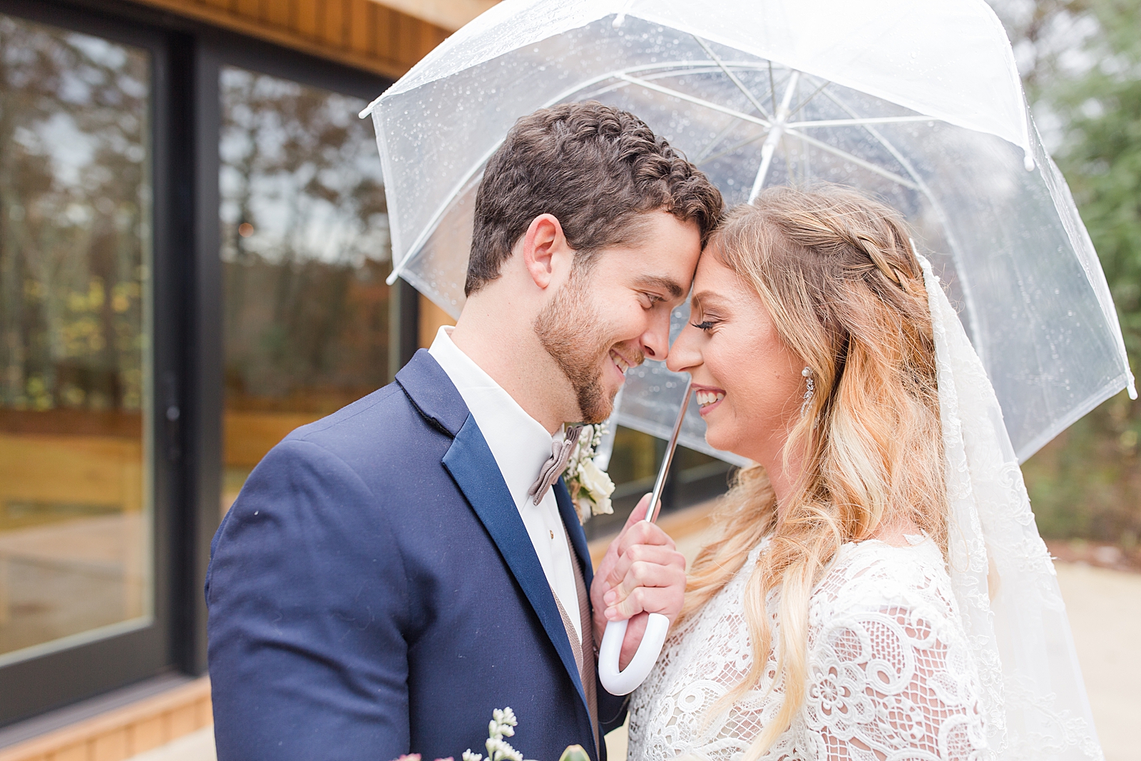 Rainy Wedding Day Couple Nose to Nose Under Umbrella Photo 