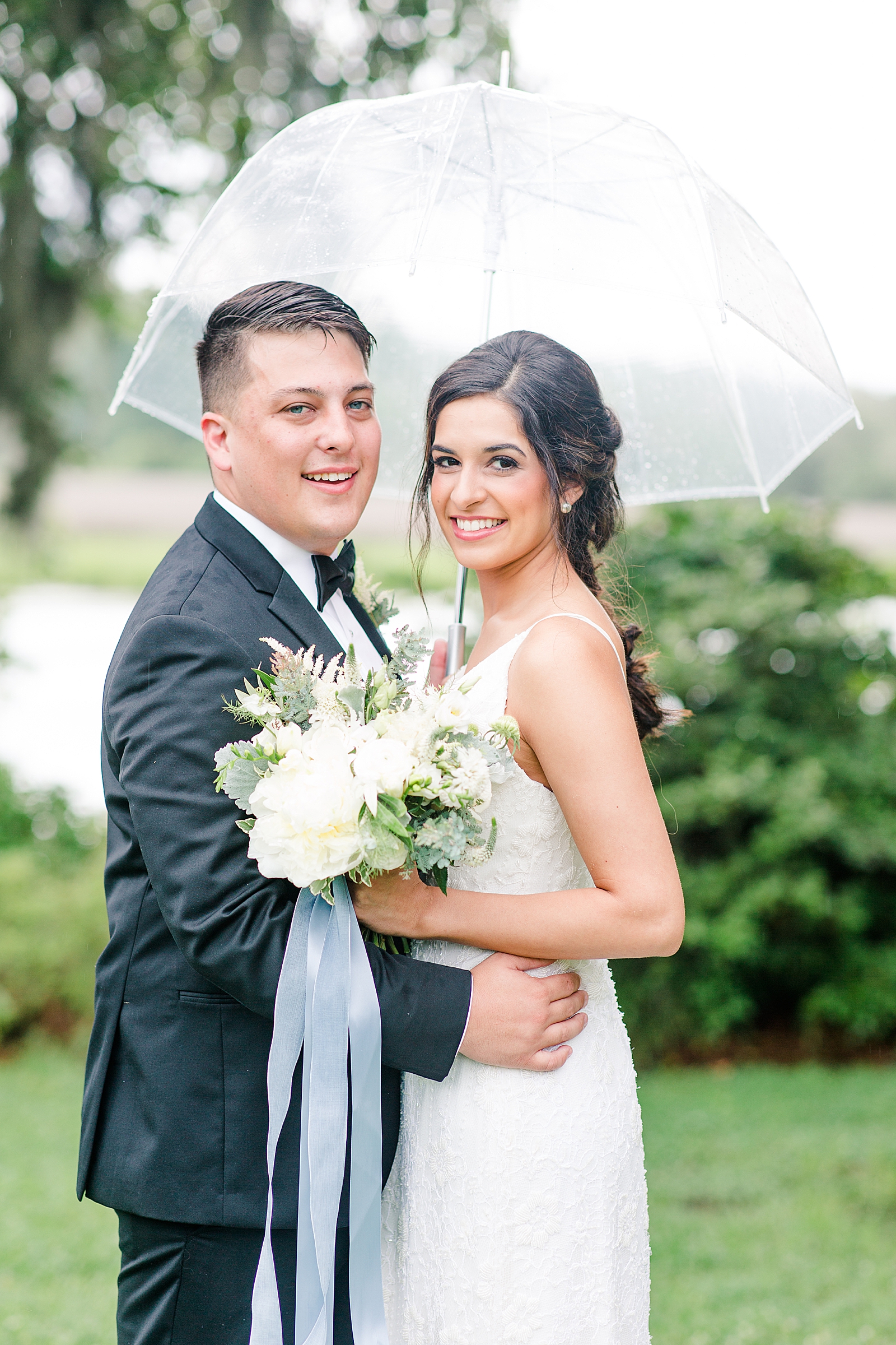 Rainy Wedding Day Couple Under Umbrella Photo 