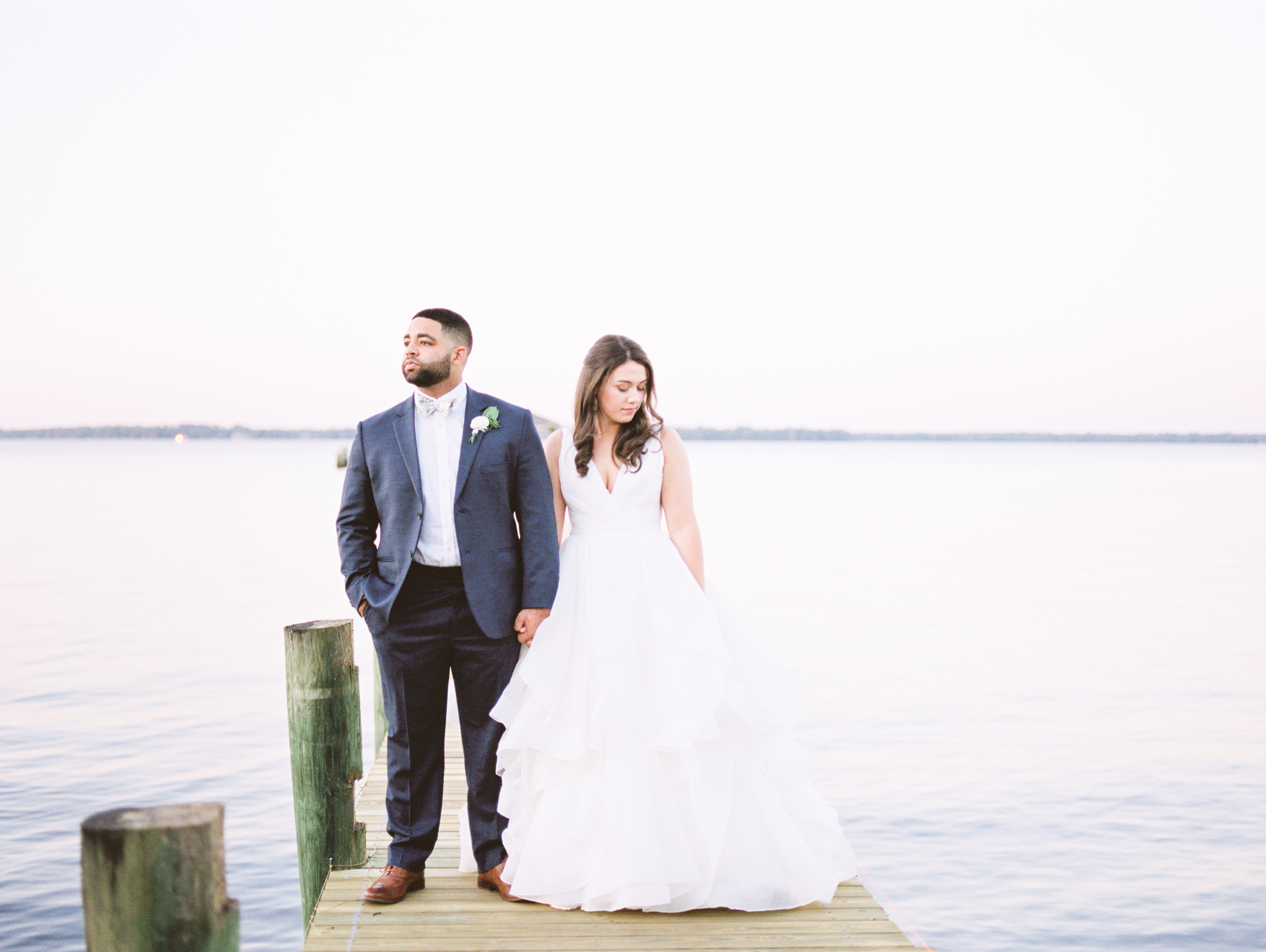 Jacksonville Florida Bride and Groom Looking off Holding Hands on Dock 