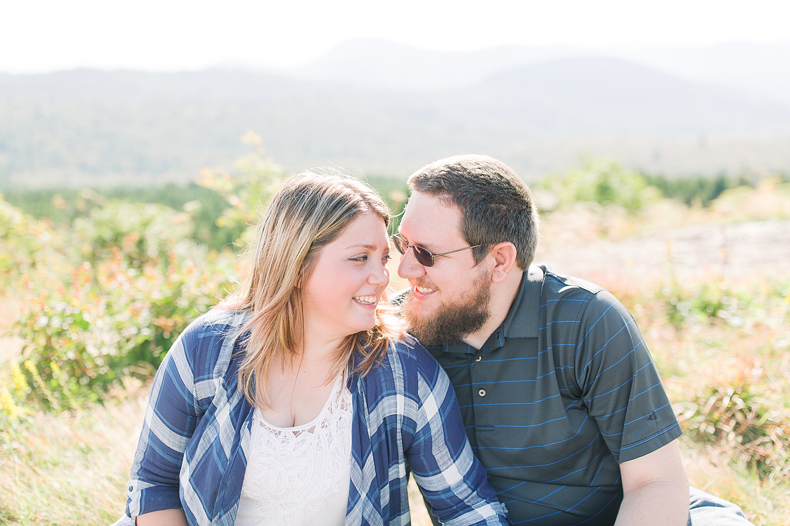 Blue Ridge Parkway Engagement Couple Sitting Smiling at Each other Photo