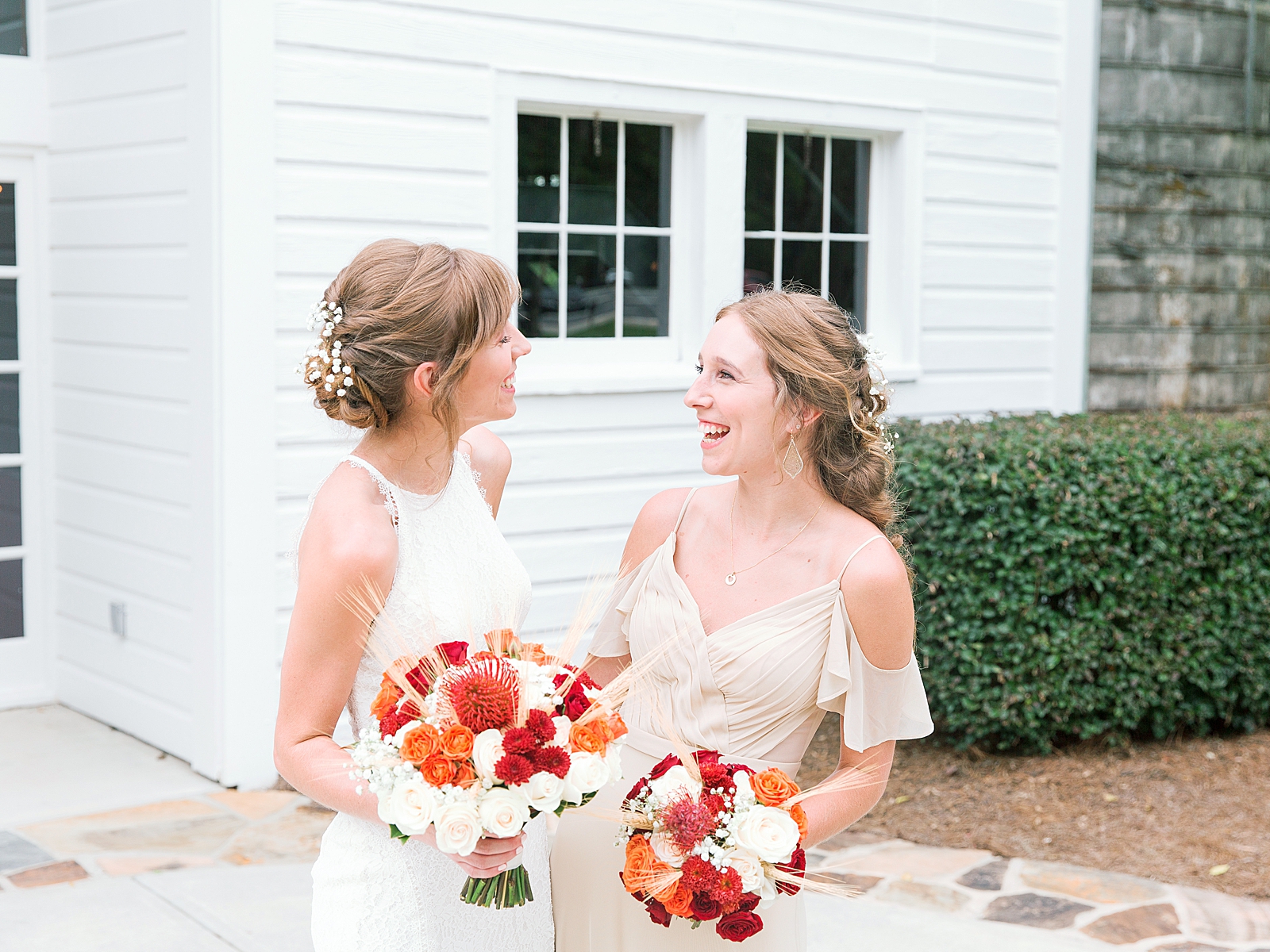 Dairy Barn Wedding Bride smiling with Matron of Honor Photo