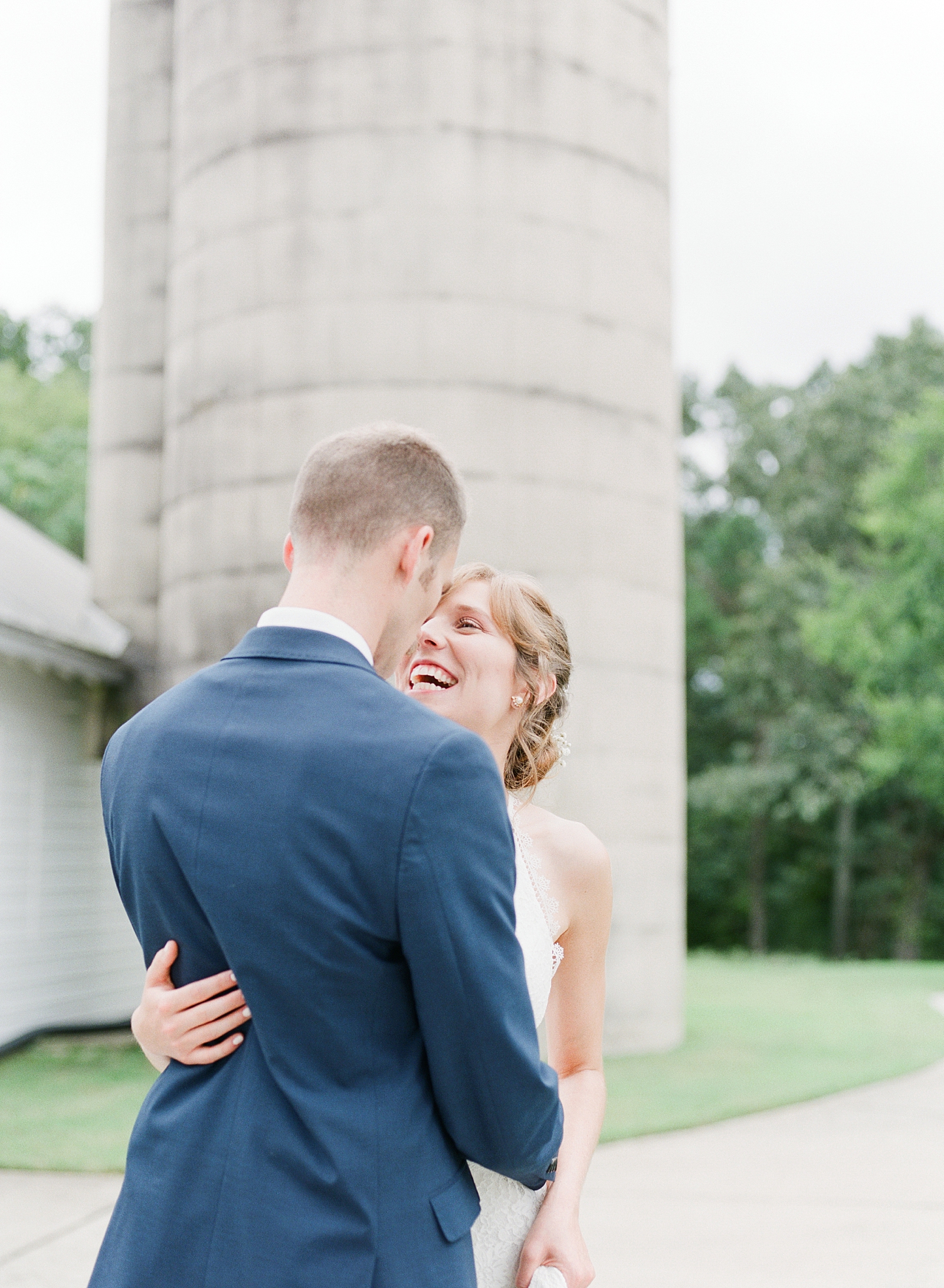 Dairy Barn Wedding Bride Laughing and Hugging Groom Photo
