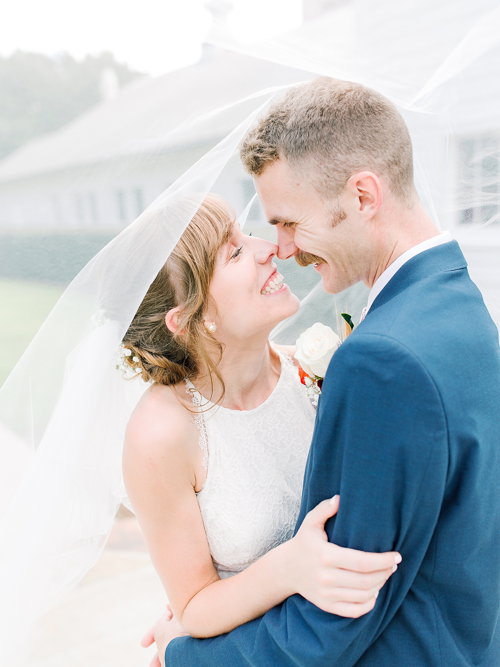 Dairy Barn Wedding Bride and Groom Nose to Nose Smiling under Veil Photo
